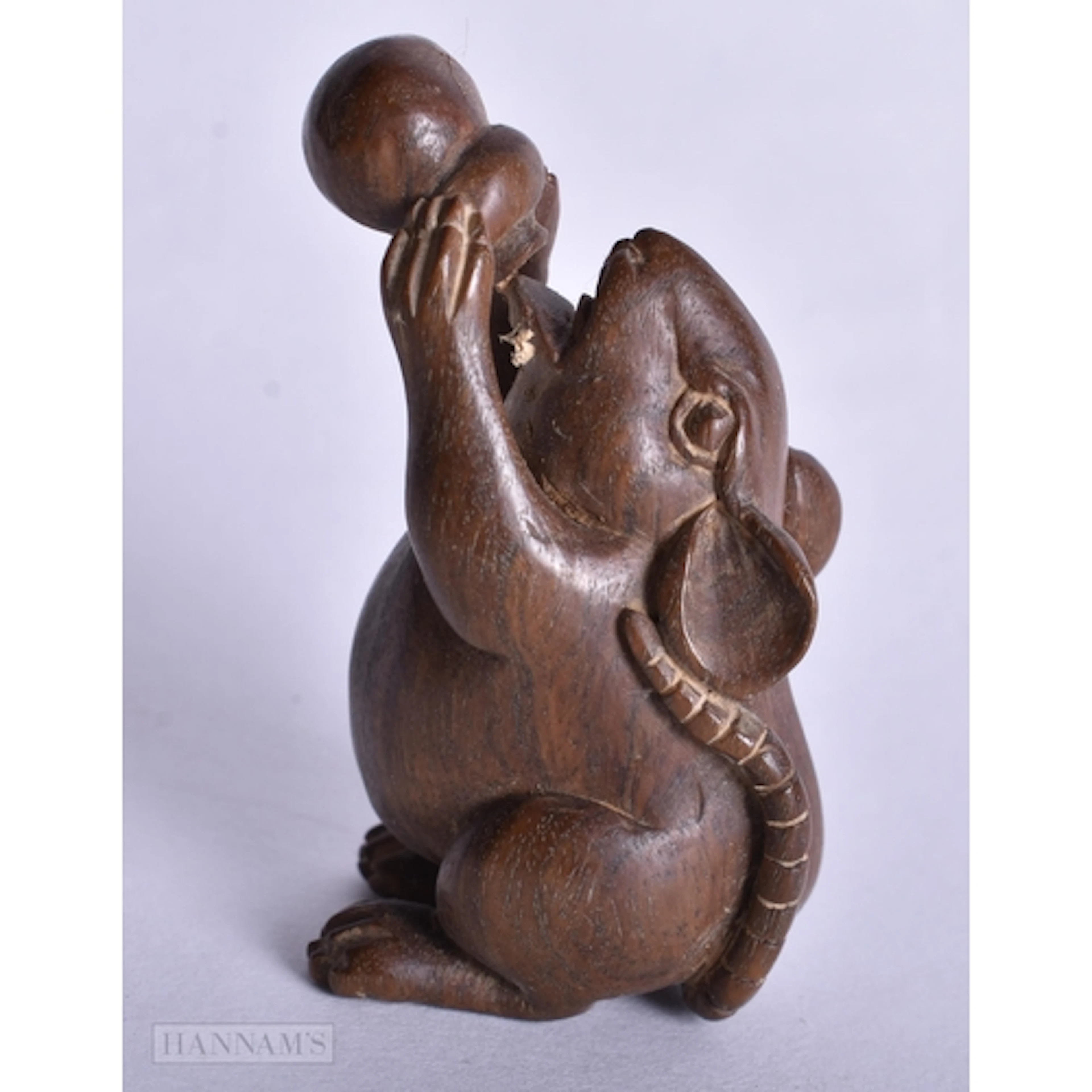A CARVED RAT AND BALL WOOD NETSUKE. 5.2 X 2.8 X 2.4 CM