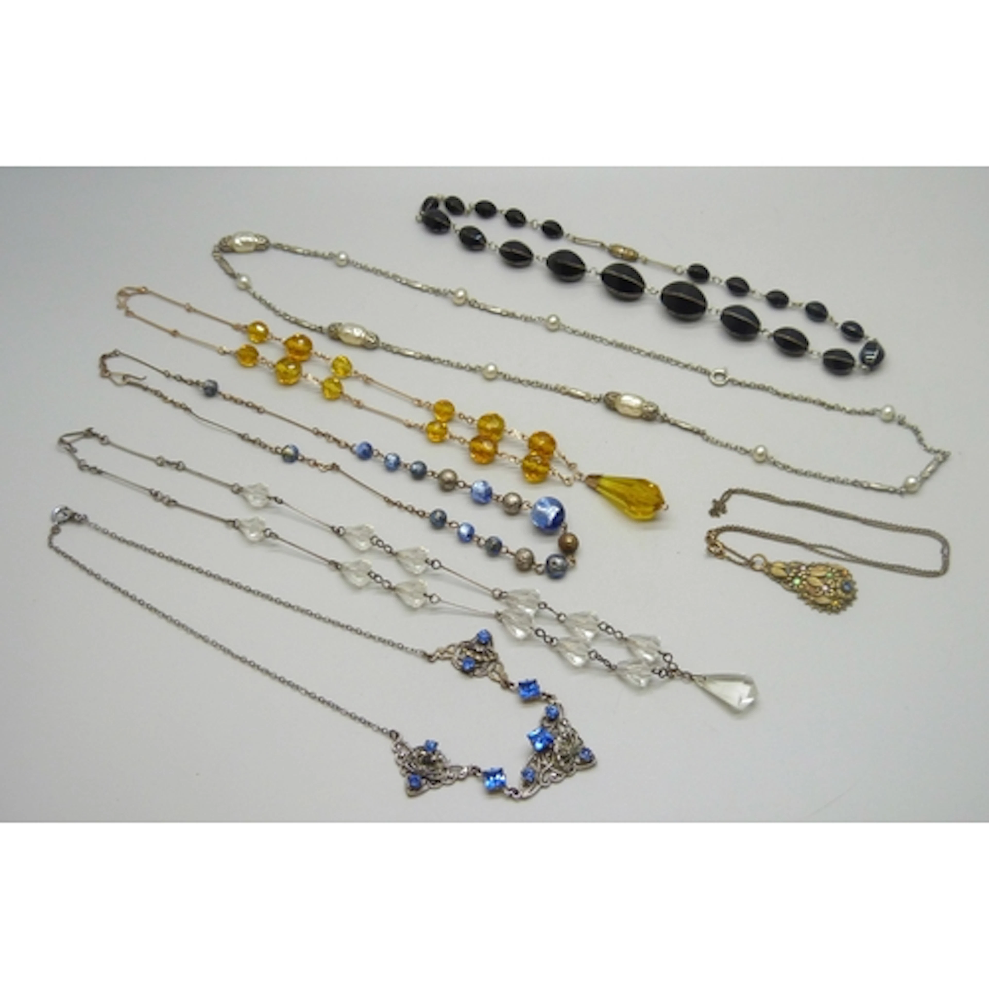 A collection of vintage costume necklaces including Art Deco...