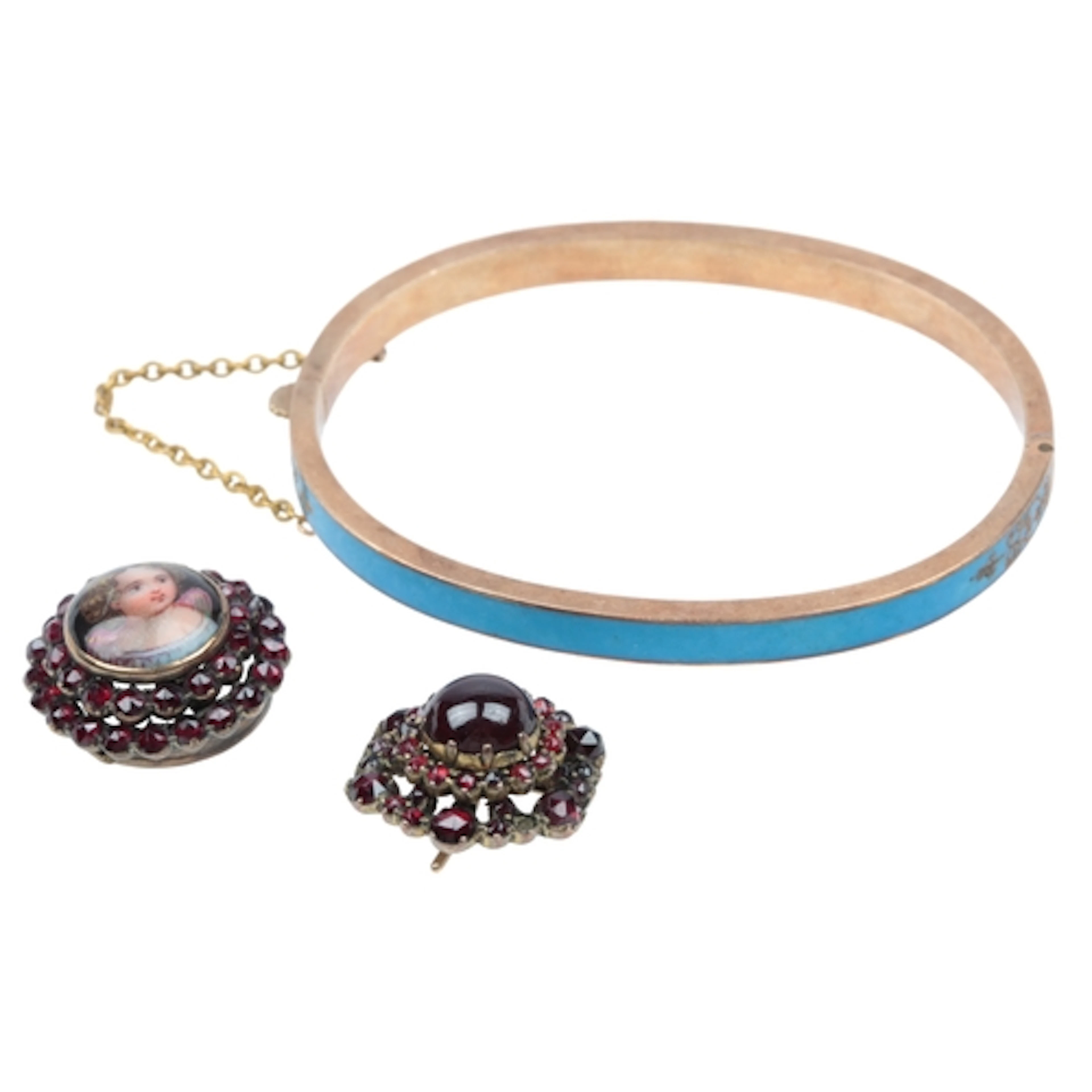 An unmarked gold bangle, of hinged design, applied with blue...