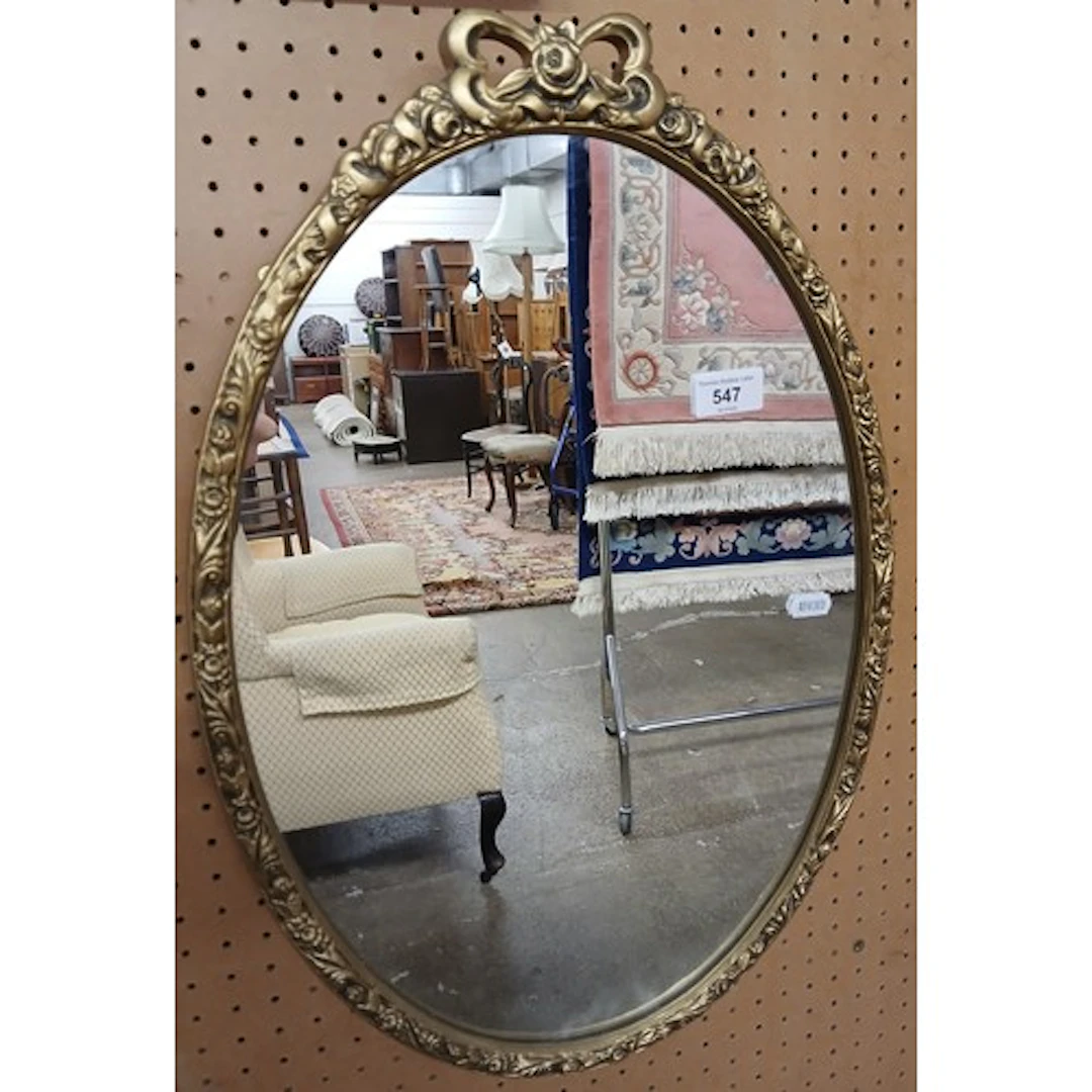 Oval gilt framed mirror.