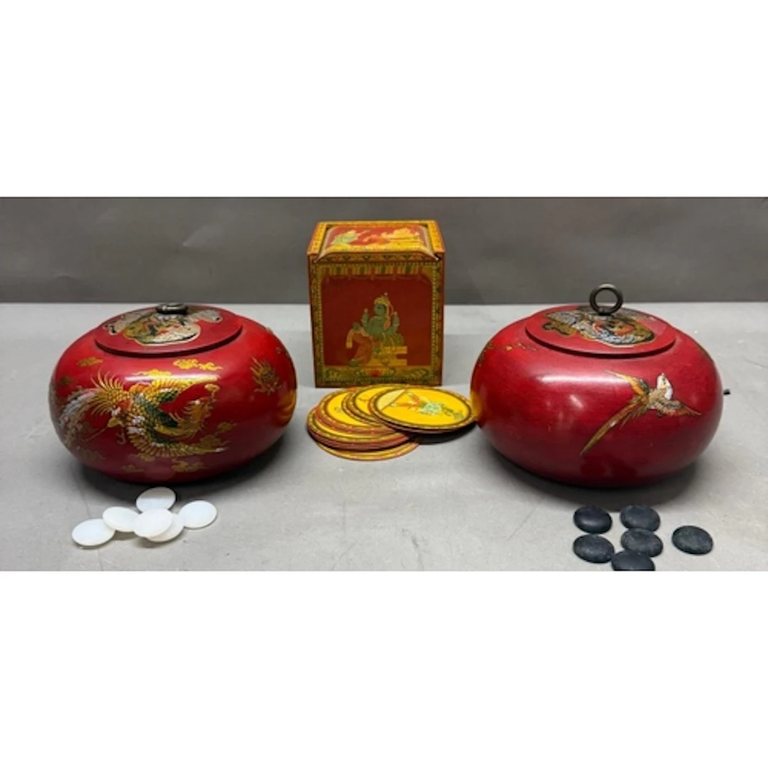 Two Chinese red lacquer lidded pots contains black and white...