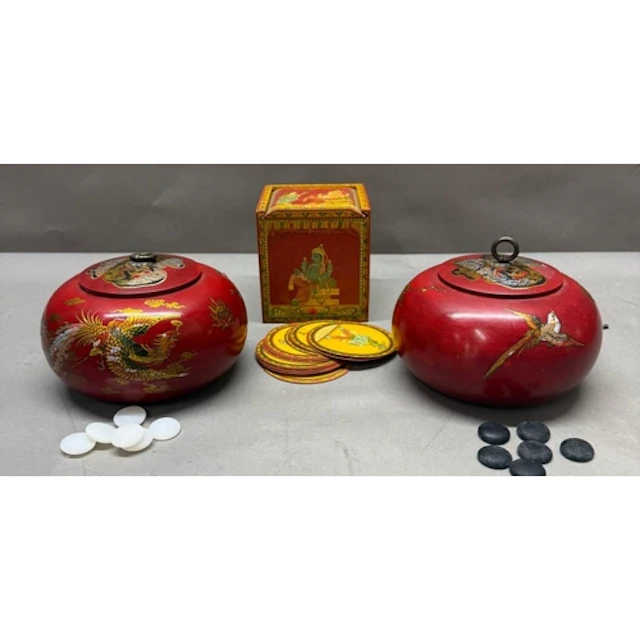 Two Chinese red lacquer lidded pots contains black and white...