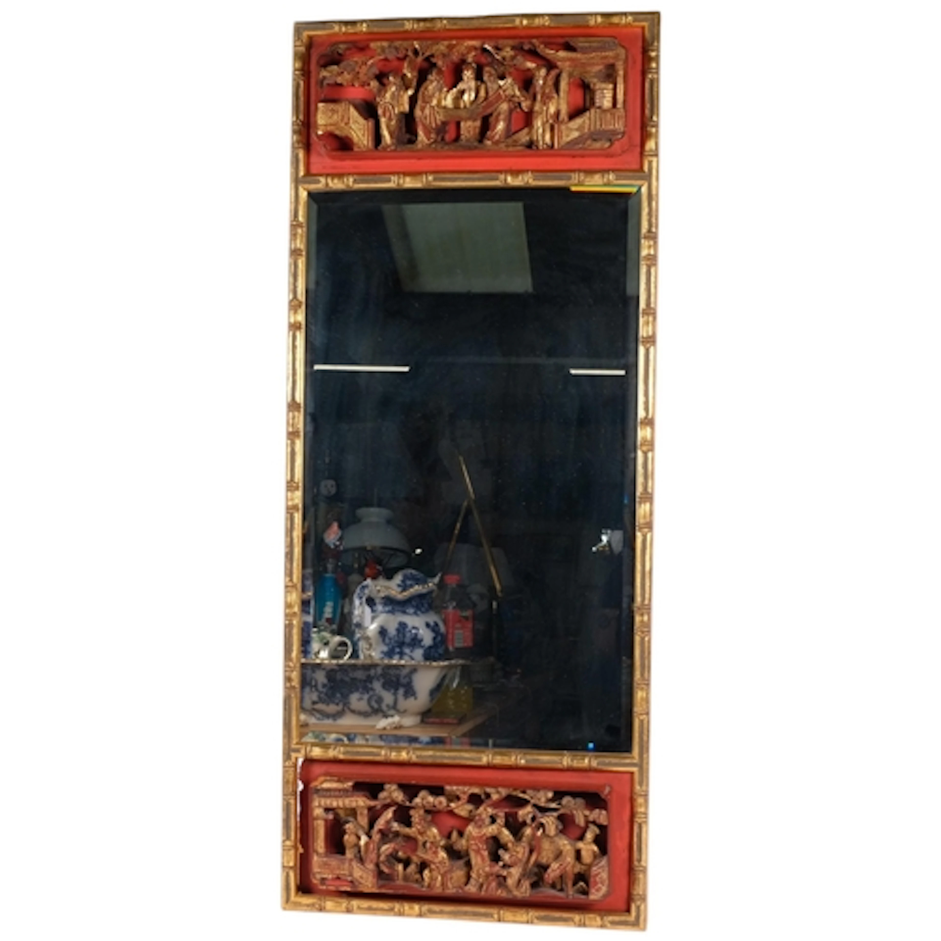 A Vintage Chinese wall mirror, the wooden frame carved to de...