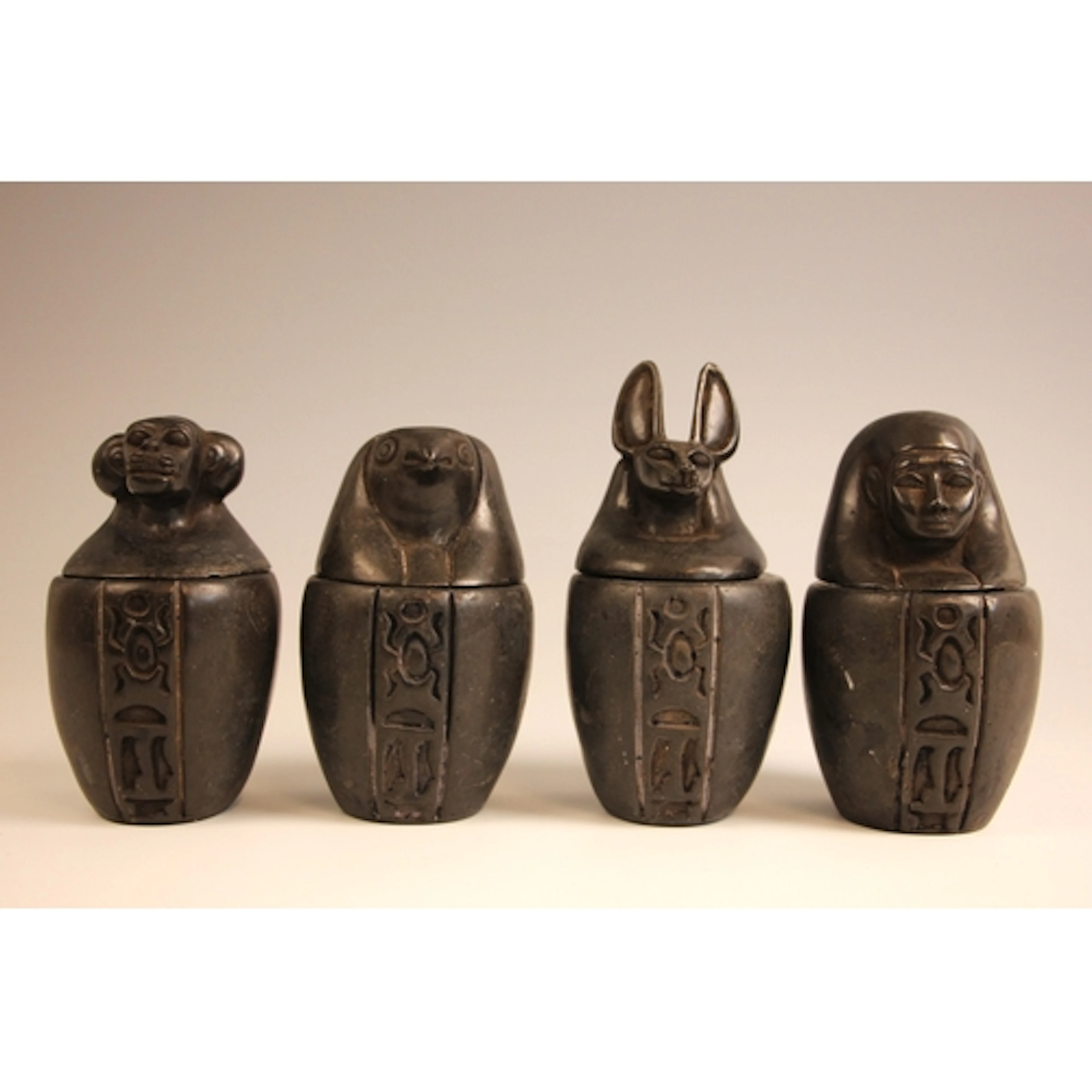 A set of four soapstone reproduction Egyptian style canopic ...
