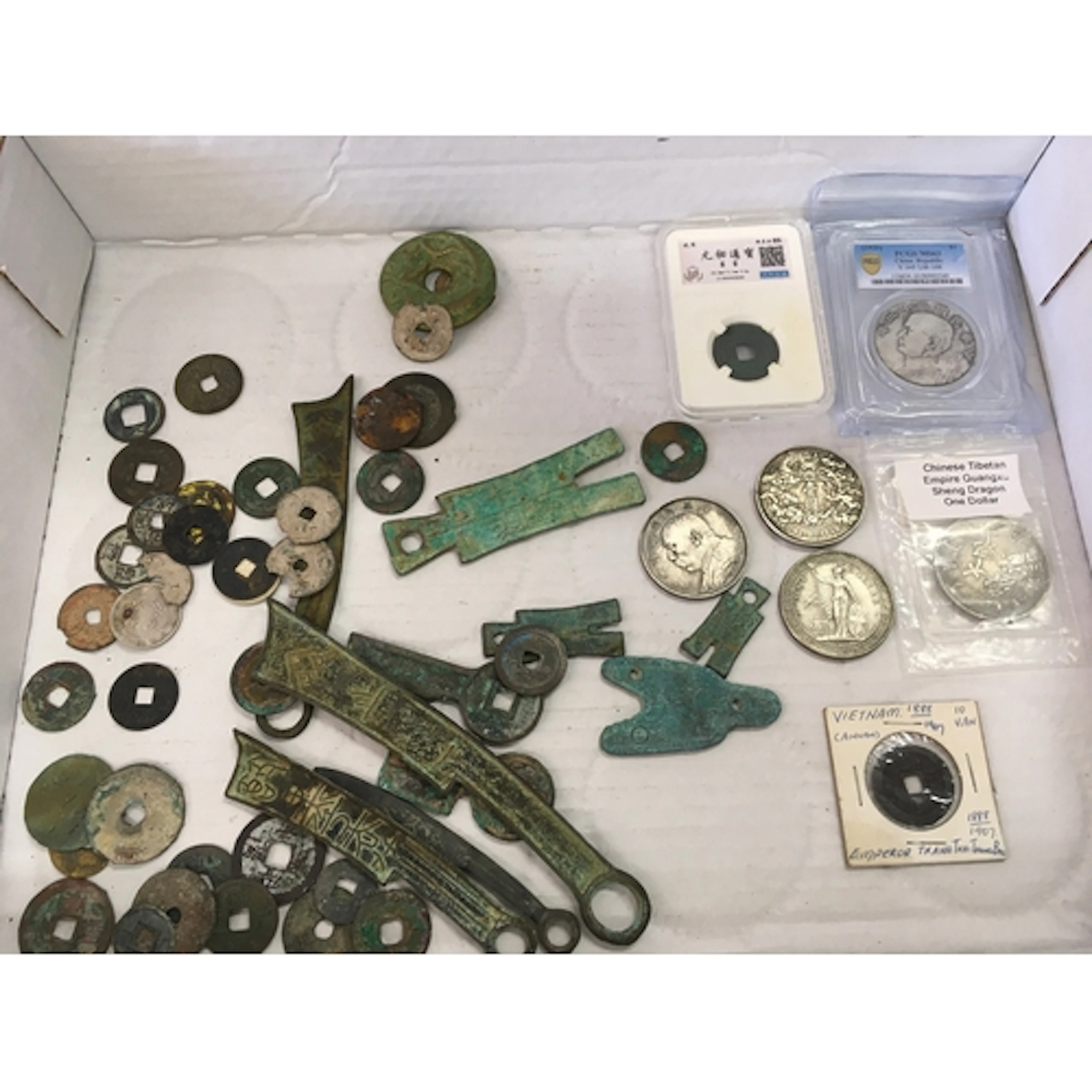 Approximately 55 Chinese and Vietnamese antique cash and swo...