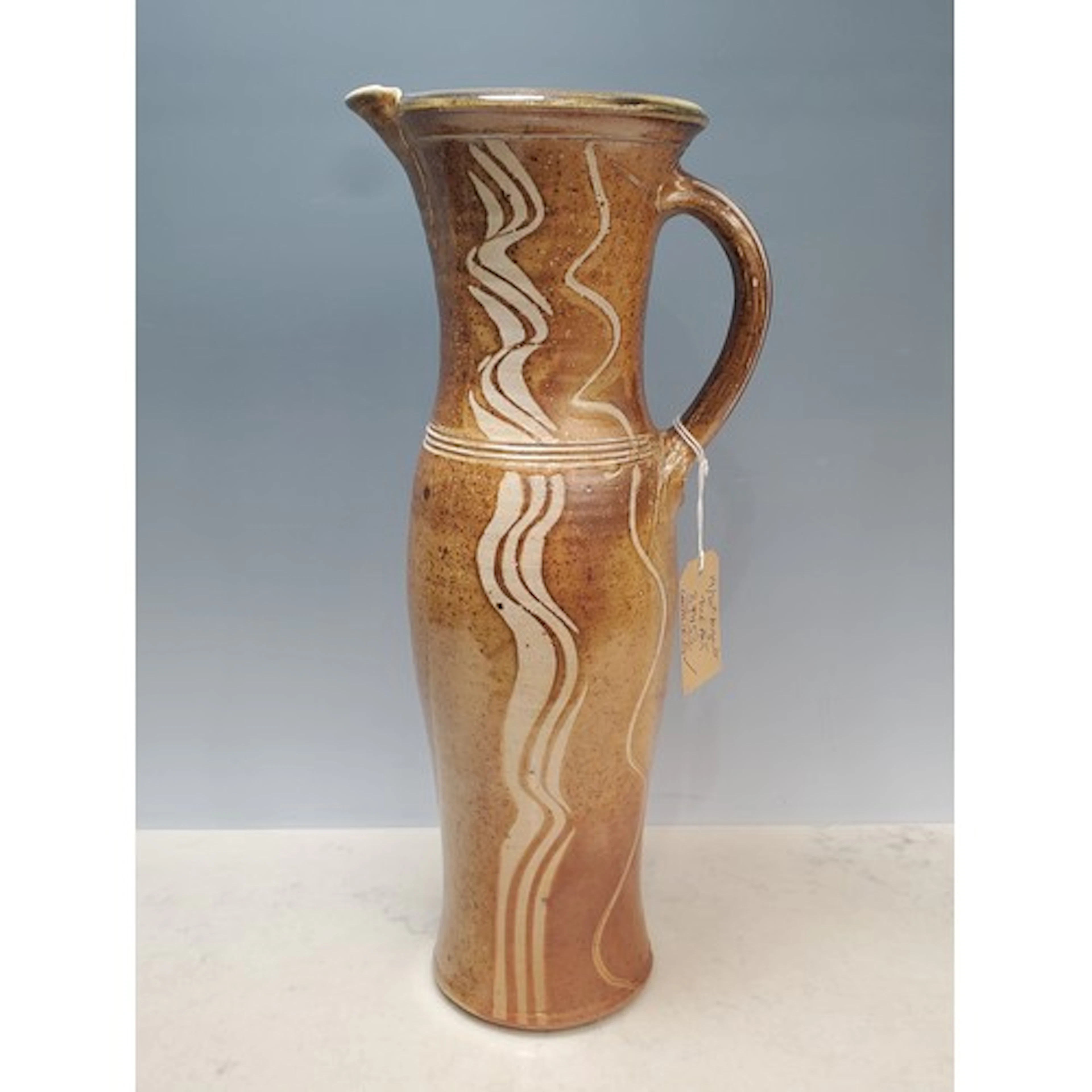 A tall slender salt-glazed stoneware Jug by Michael Casson (...