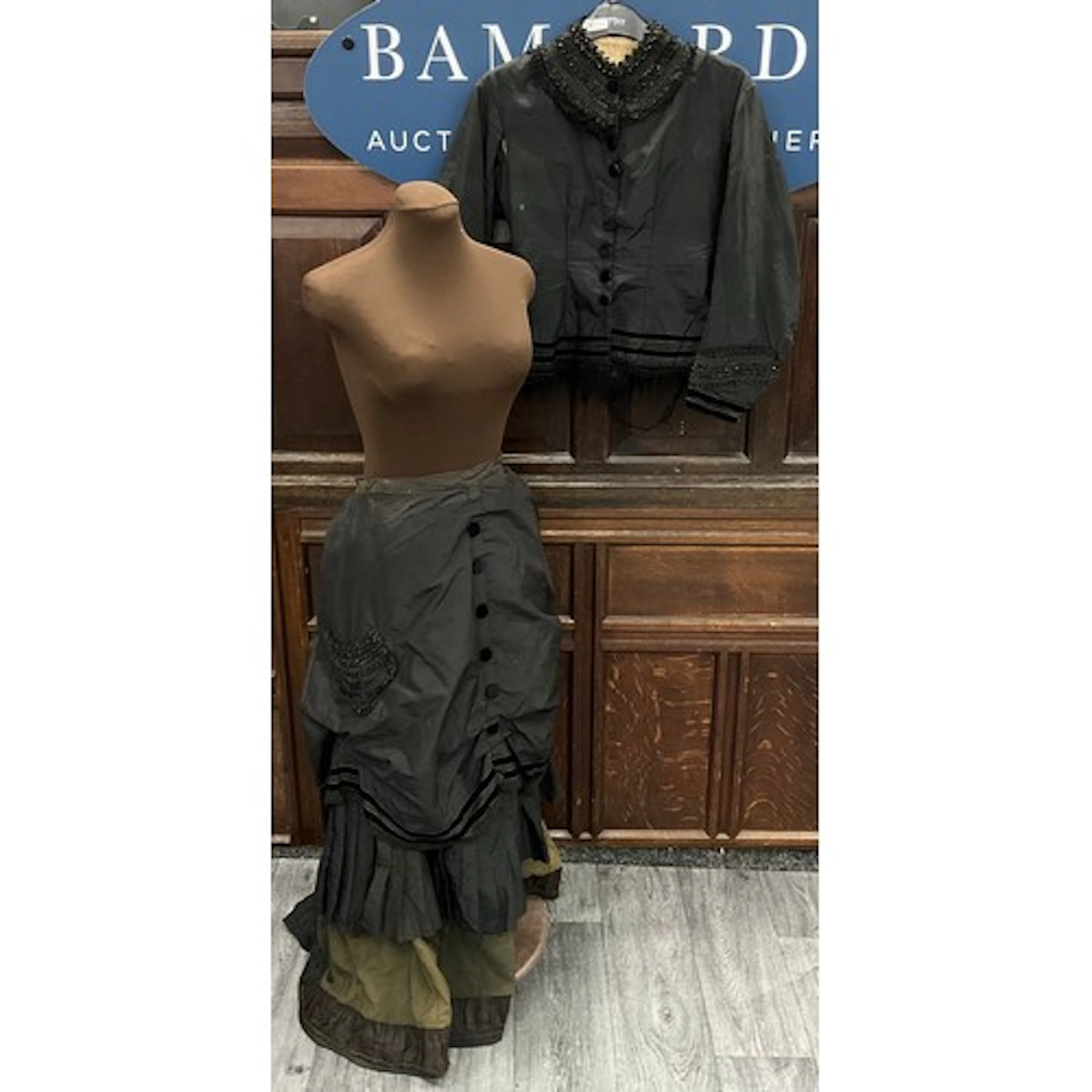 A Victorian mourning bodice, likely made of silk taffeta or ...