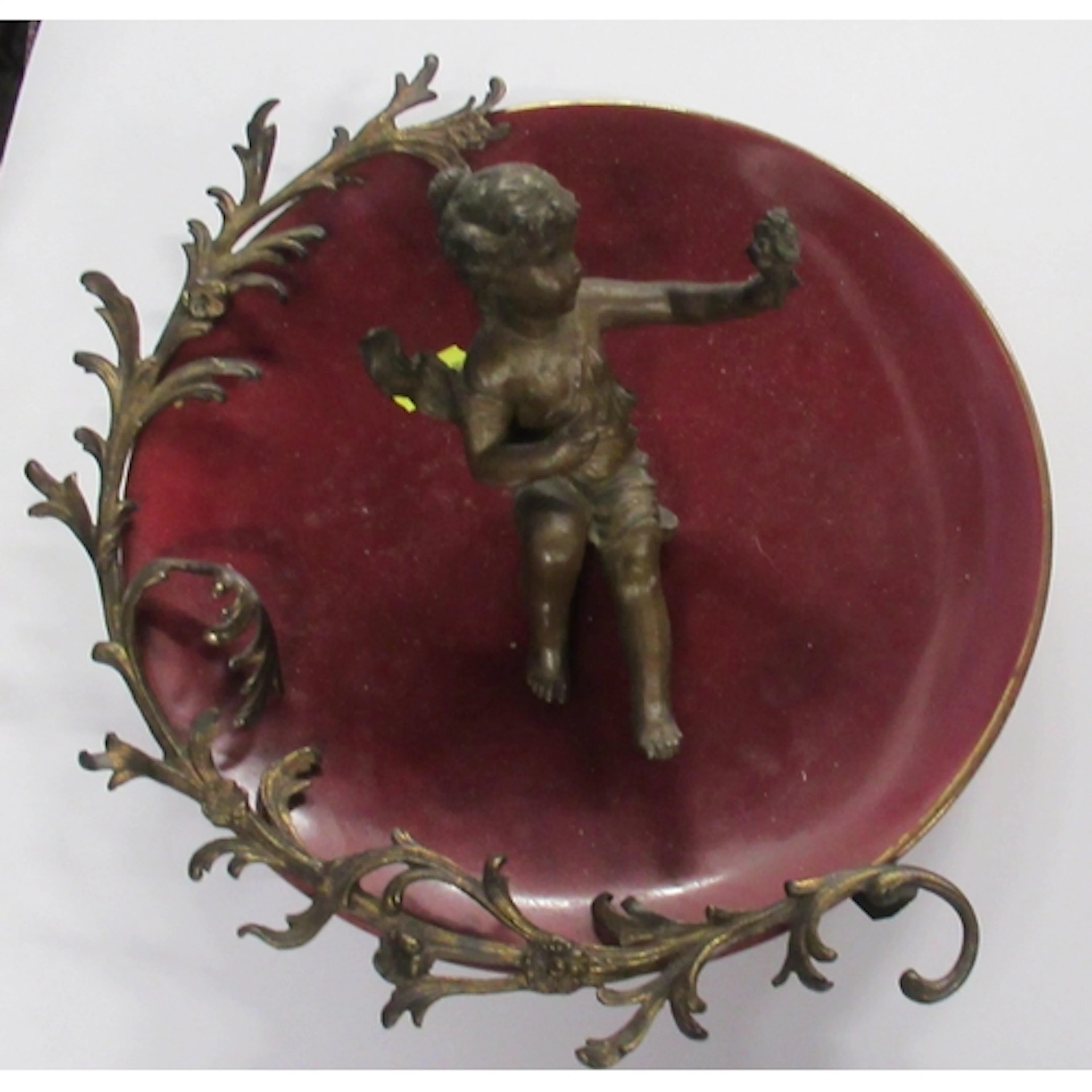 A burgundy ground porcelain plate, with metal mount to the r...