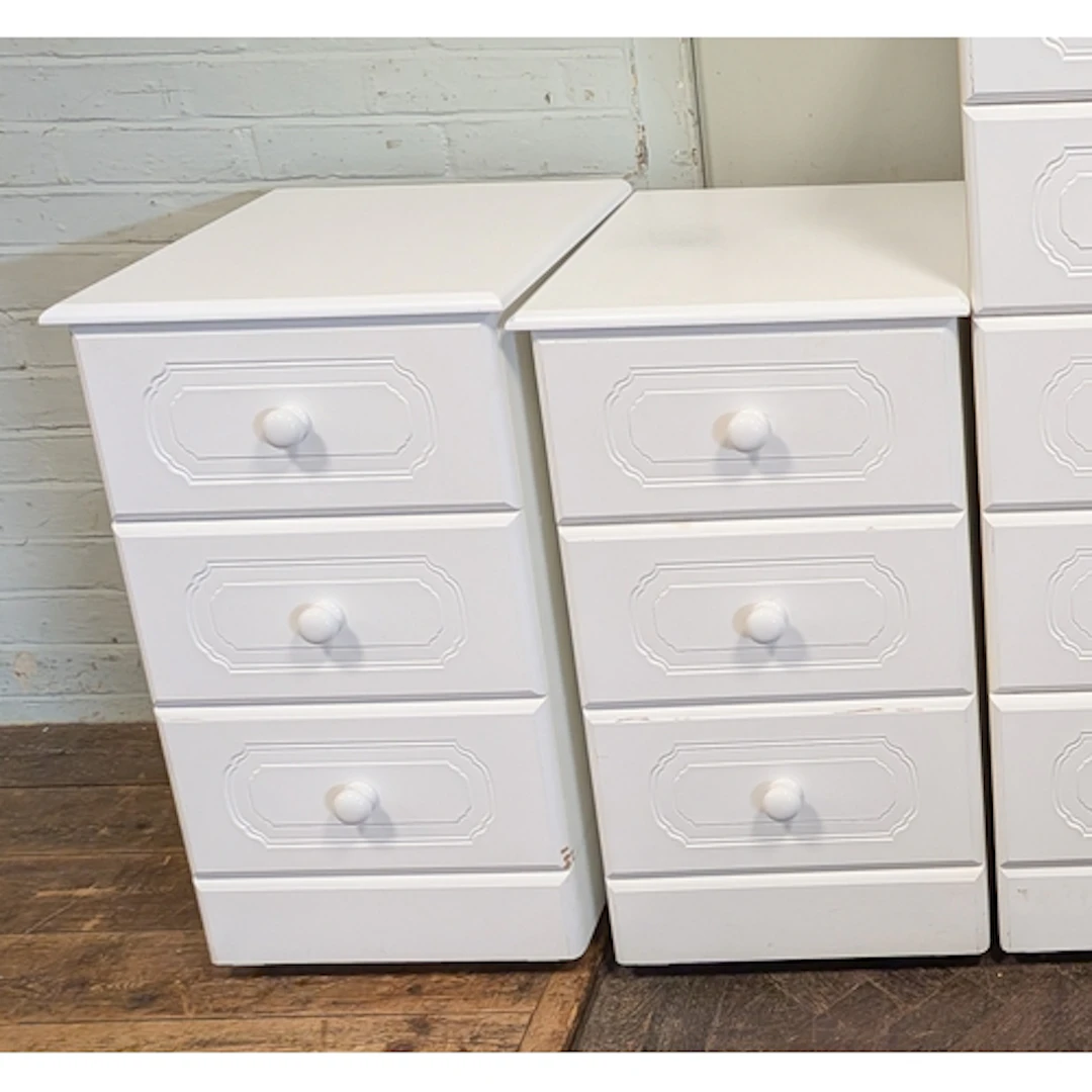 A pair of white three drawer bedside chests, matching the pr...