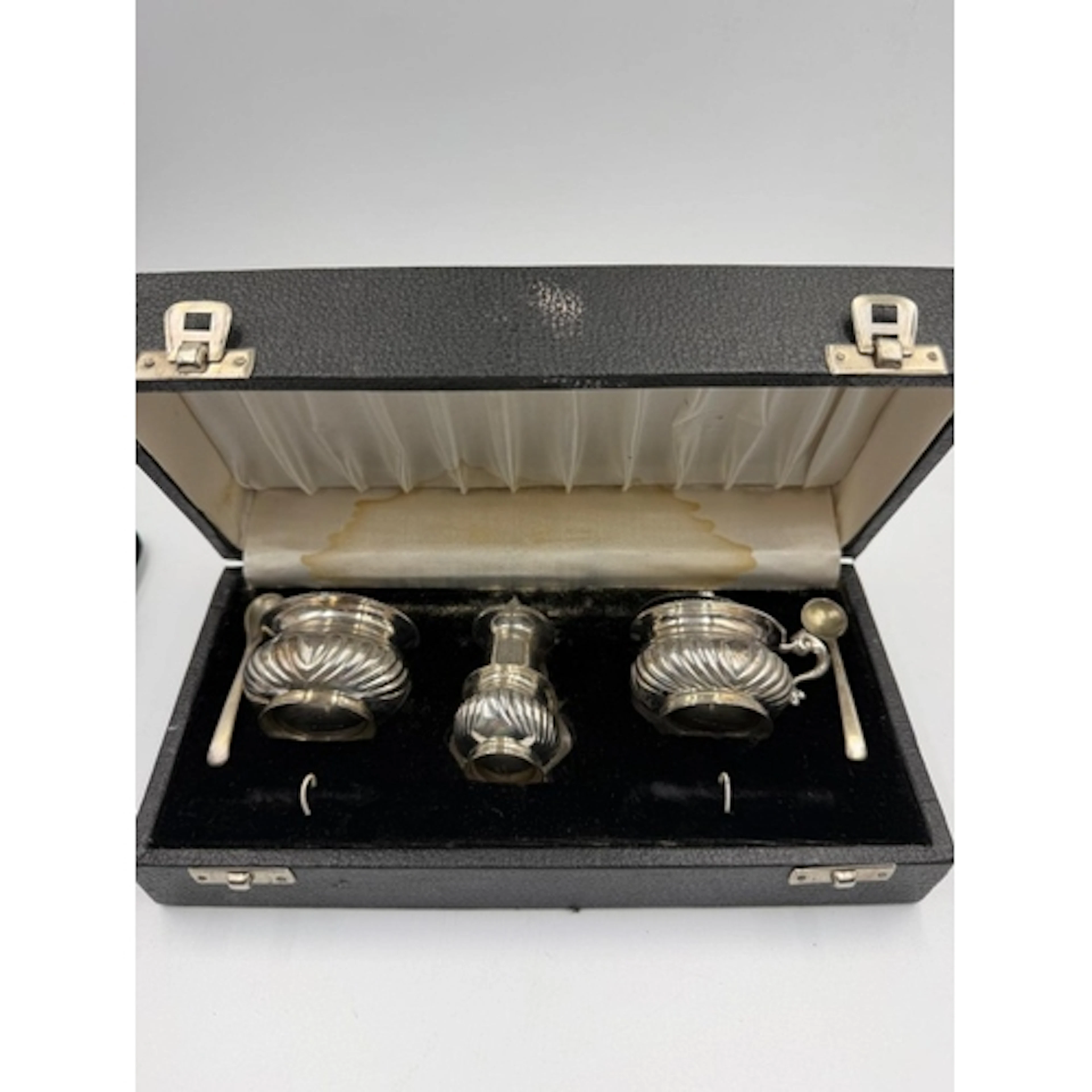 A Sterling Silver cruet set, to include salt, mustard and pe...