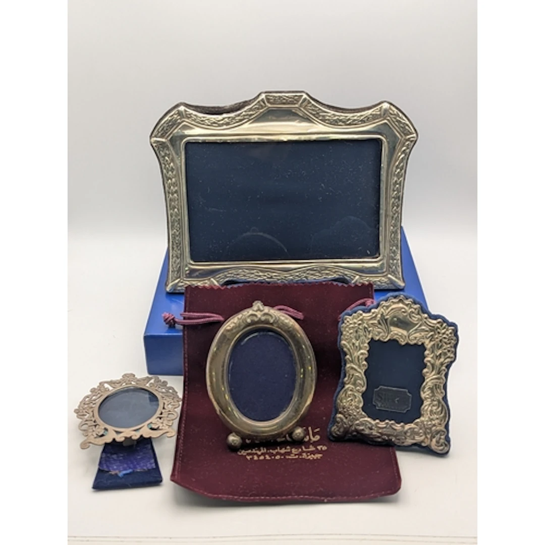 Four silver fronted easel back photograph frames, to include...