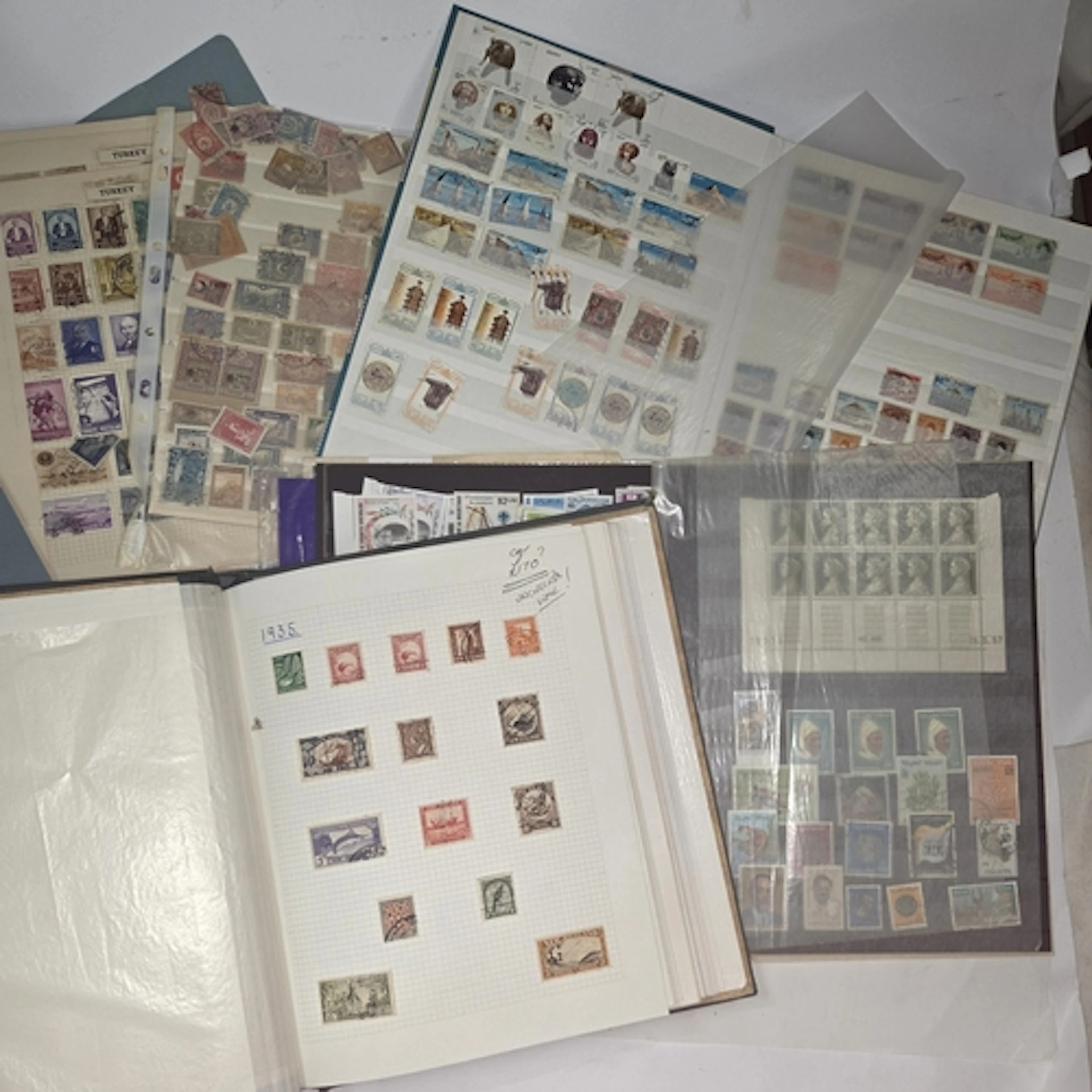 An album and loose sheets of New Zeland stamps, and two othe...