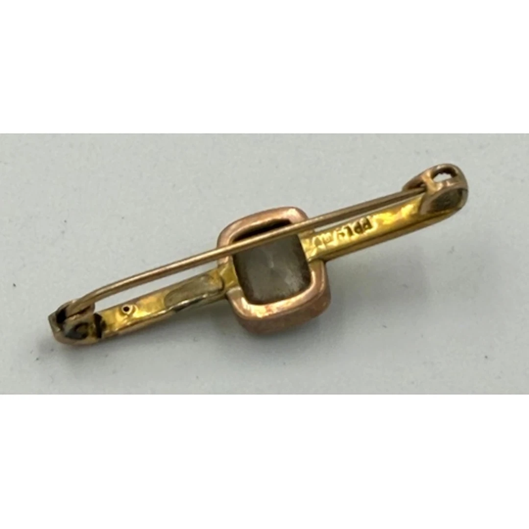A 9ct gold bar brooch with central clear stone, approximate ...