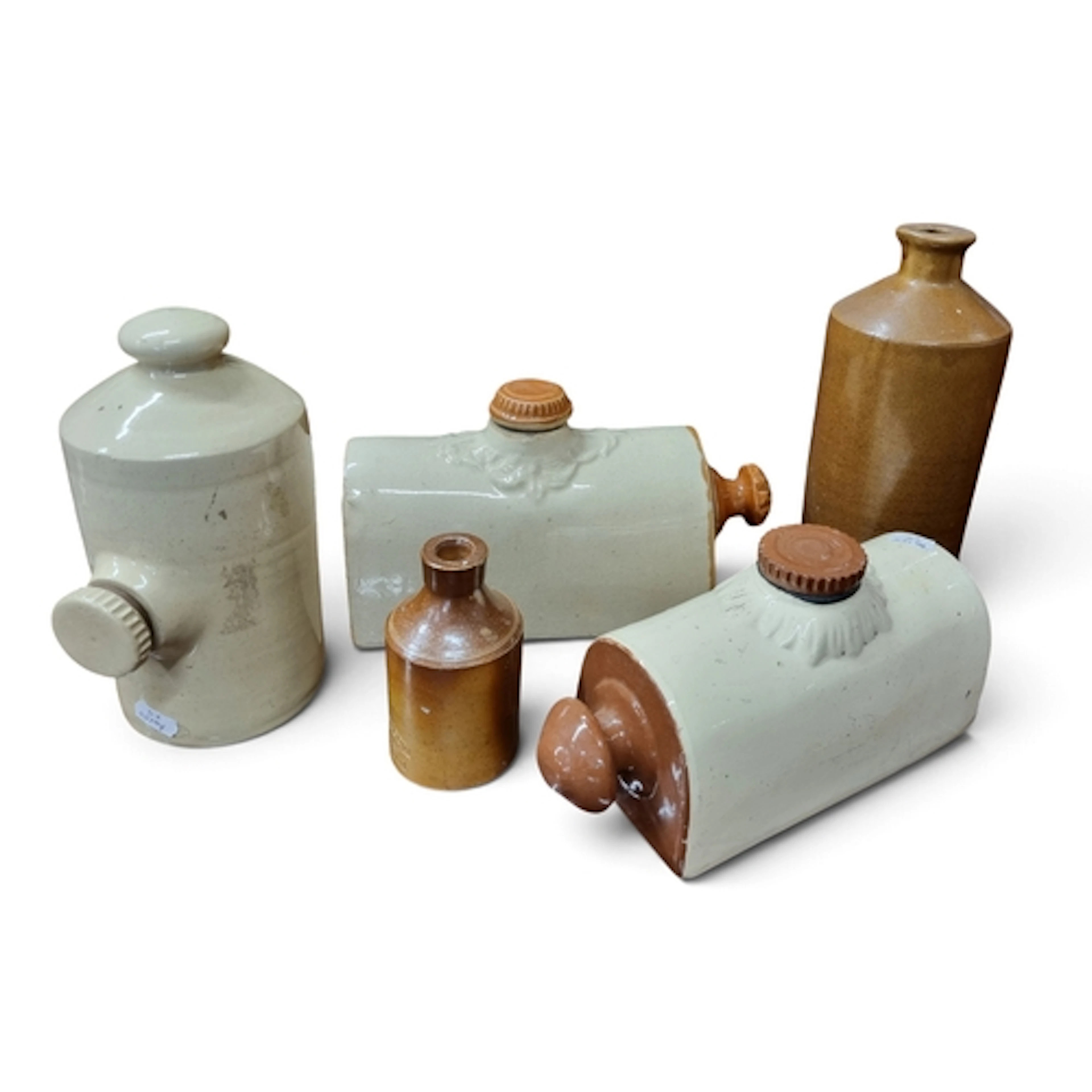 A collection of antique stoneware bottles comprising a Holli...