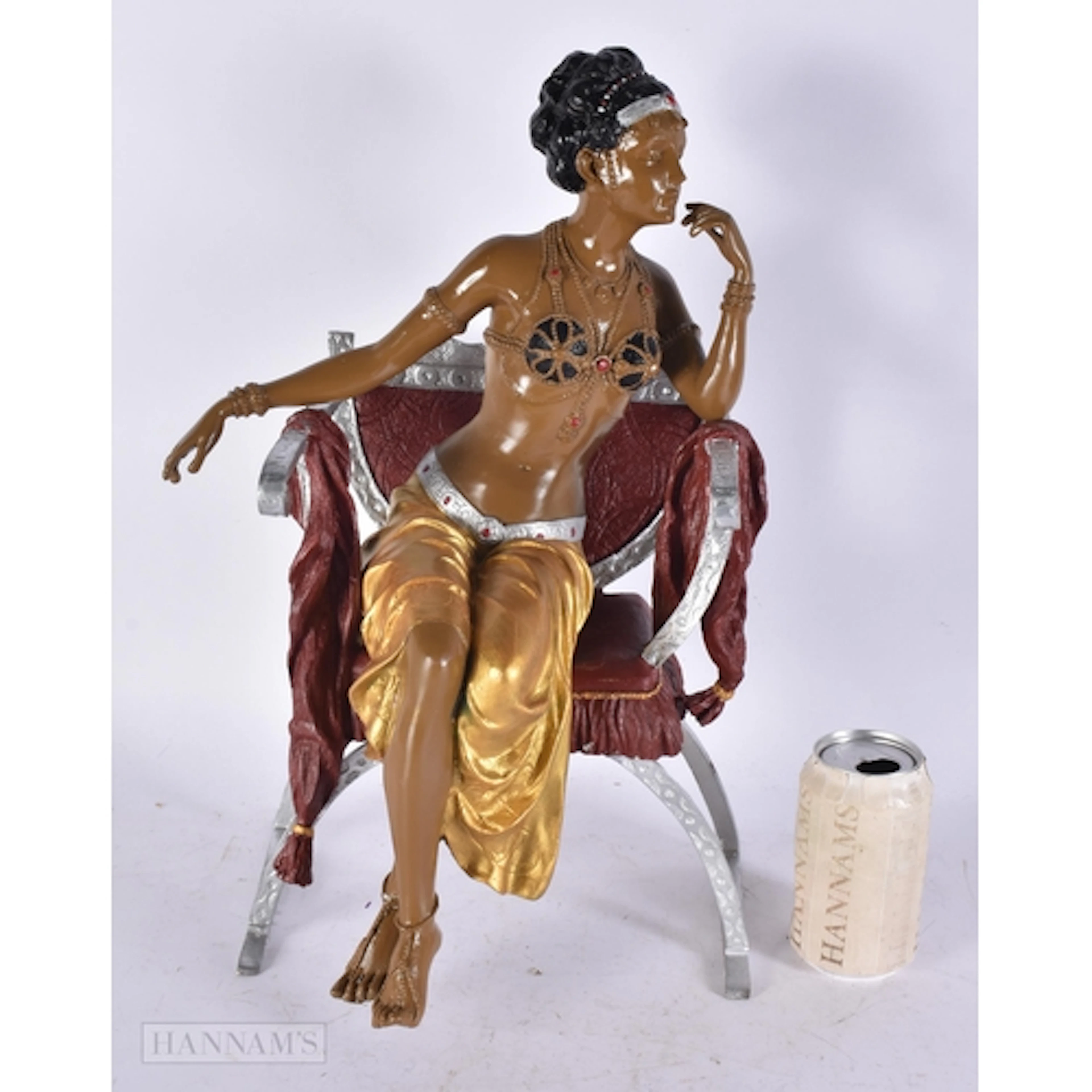 A PAINTED BRONZE FLAPPER GIRL IN CHAIR. 43 cm x 18 cm.