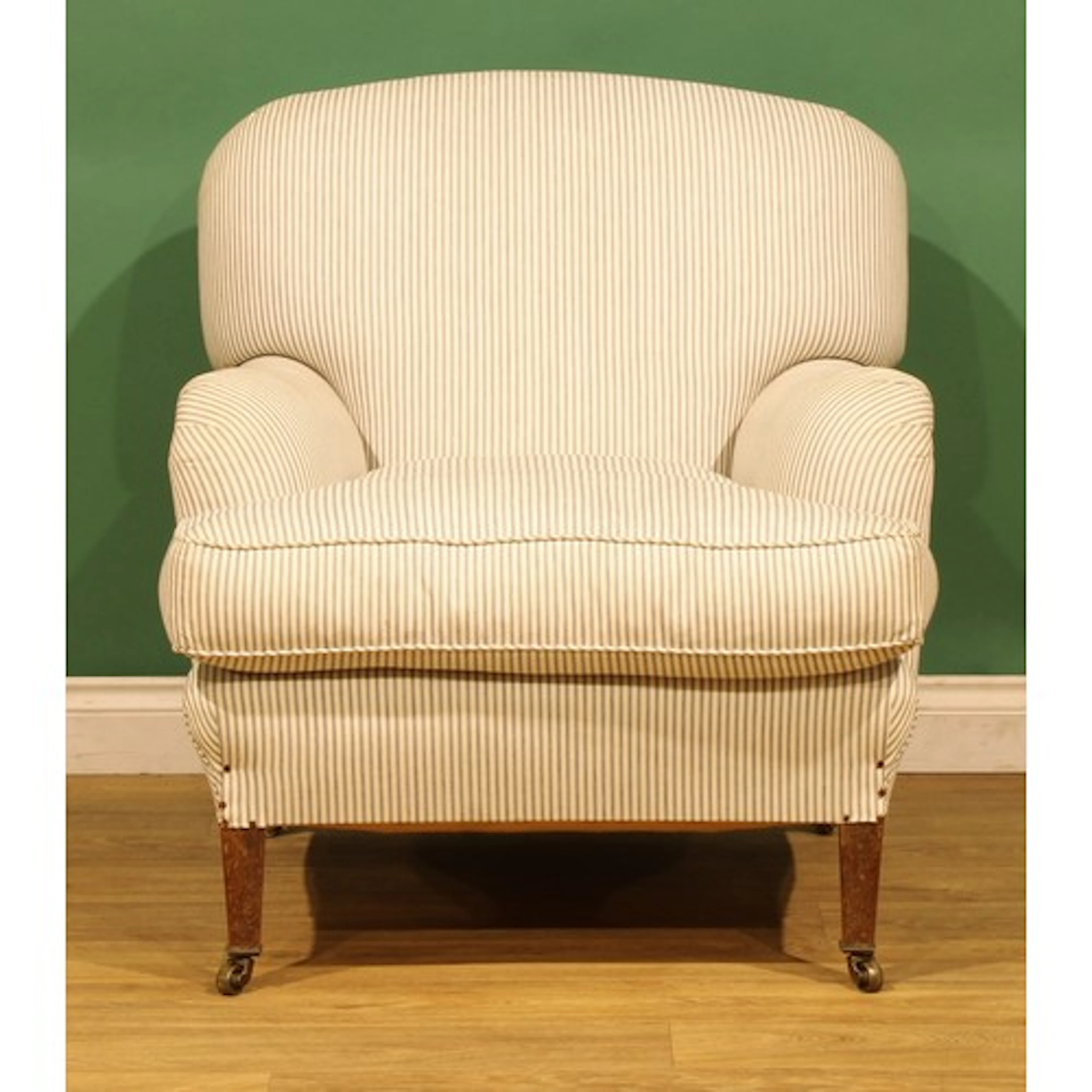 A late Victorian/Edwardian easy chair, by Howard & Sons Ltd,...