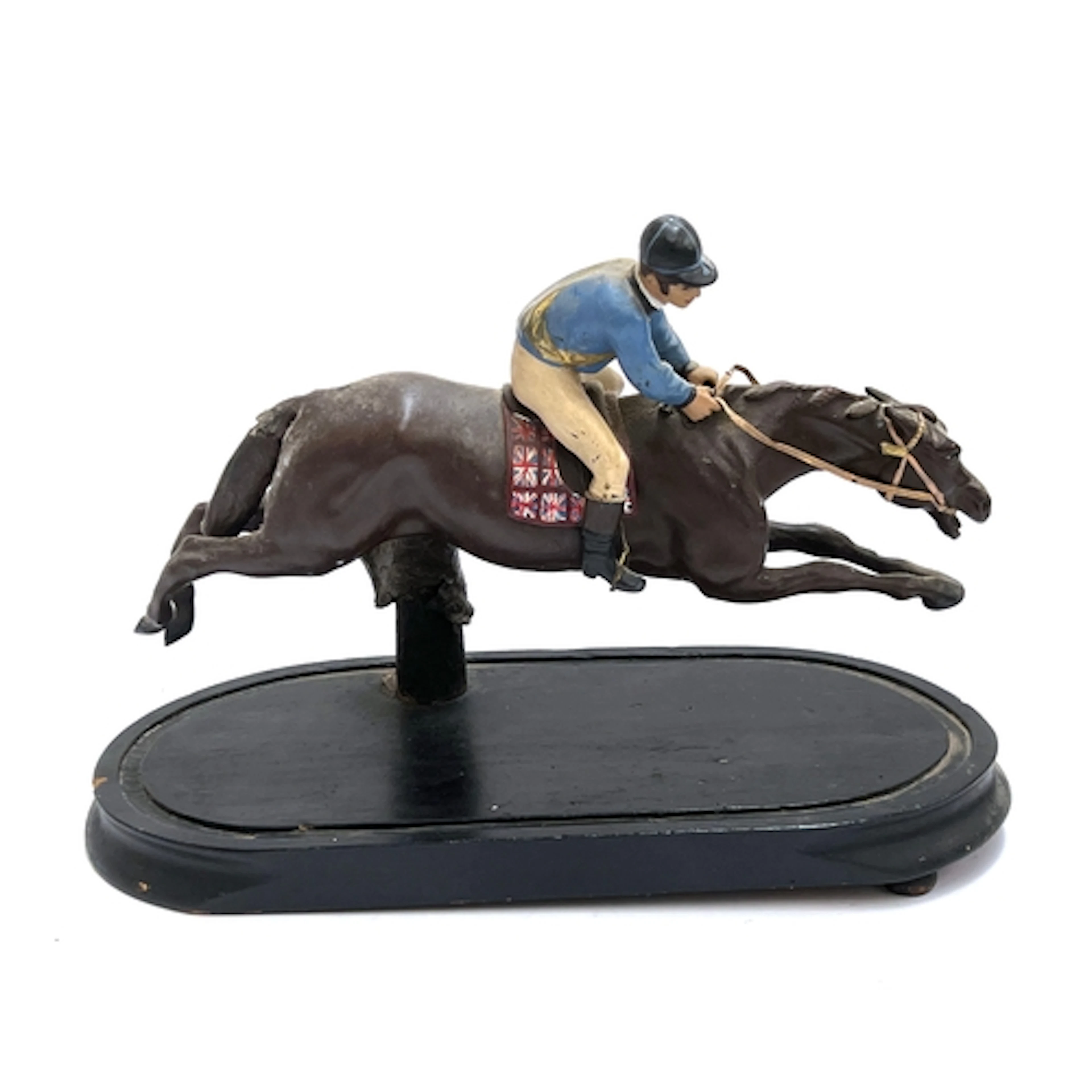 A painted spelted figure of a jockey up, approx. 34cmL
