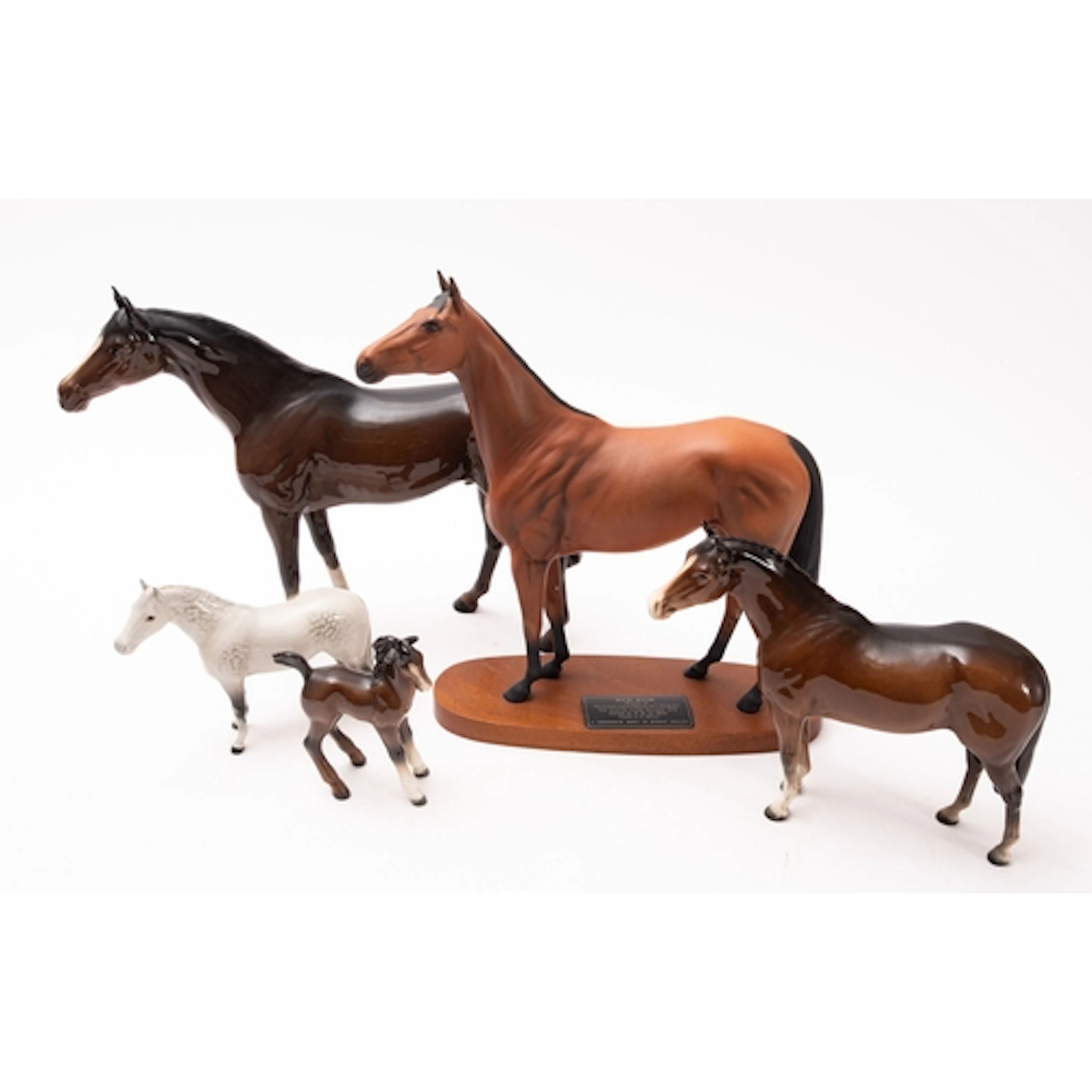 Five Beswick porcelain horses, including Red Rum, in a range...