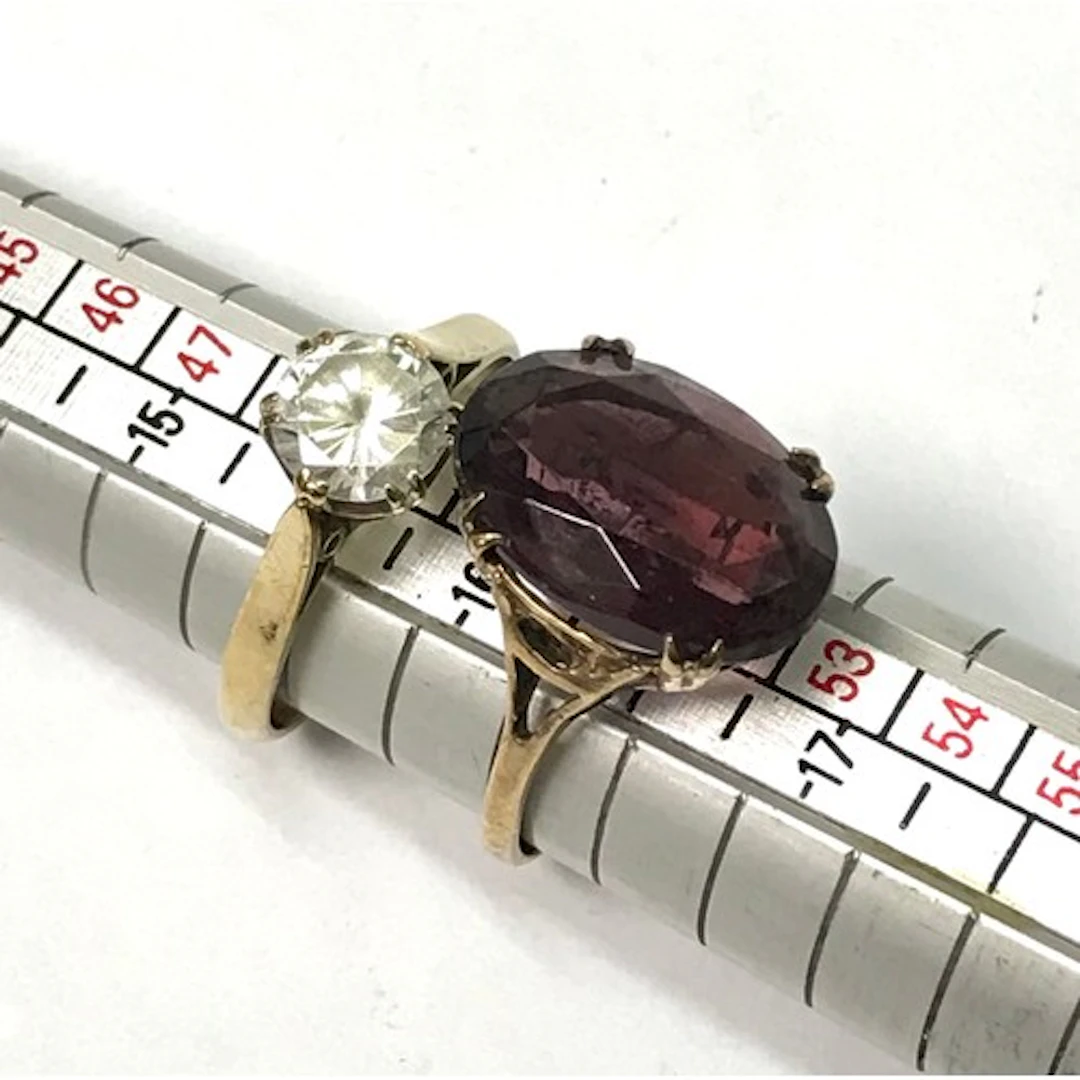A 9ct gold cocktail ring; a 9ct gold and paste solitaire rin...