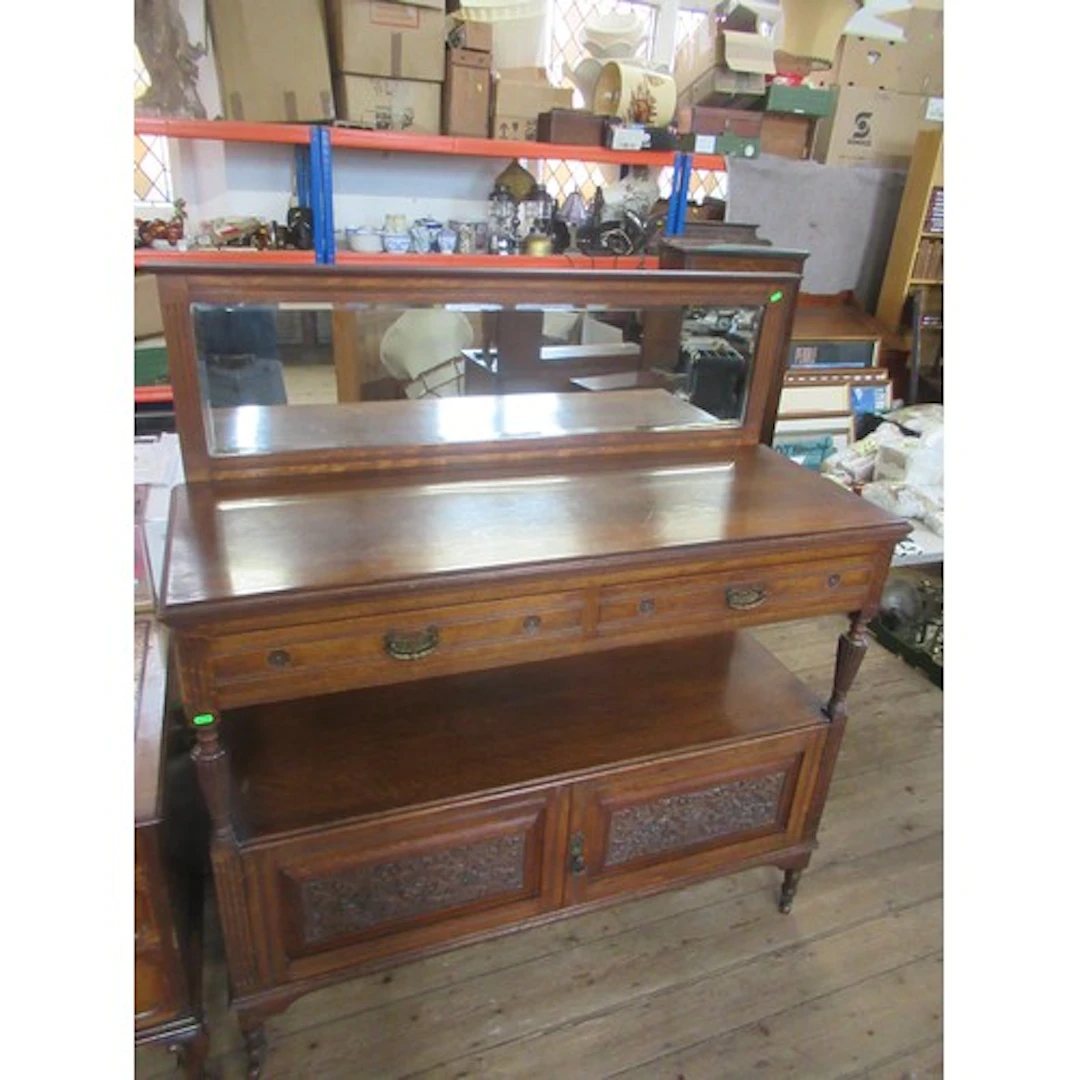 An Edwardian Oak buffet with mirror back having carved decor...