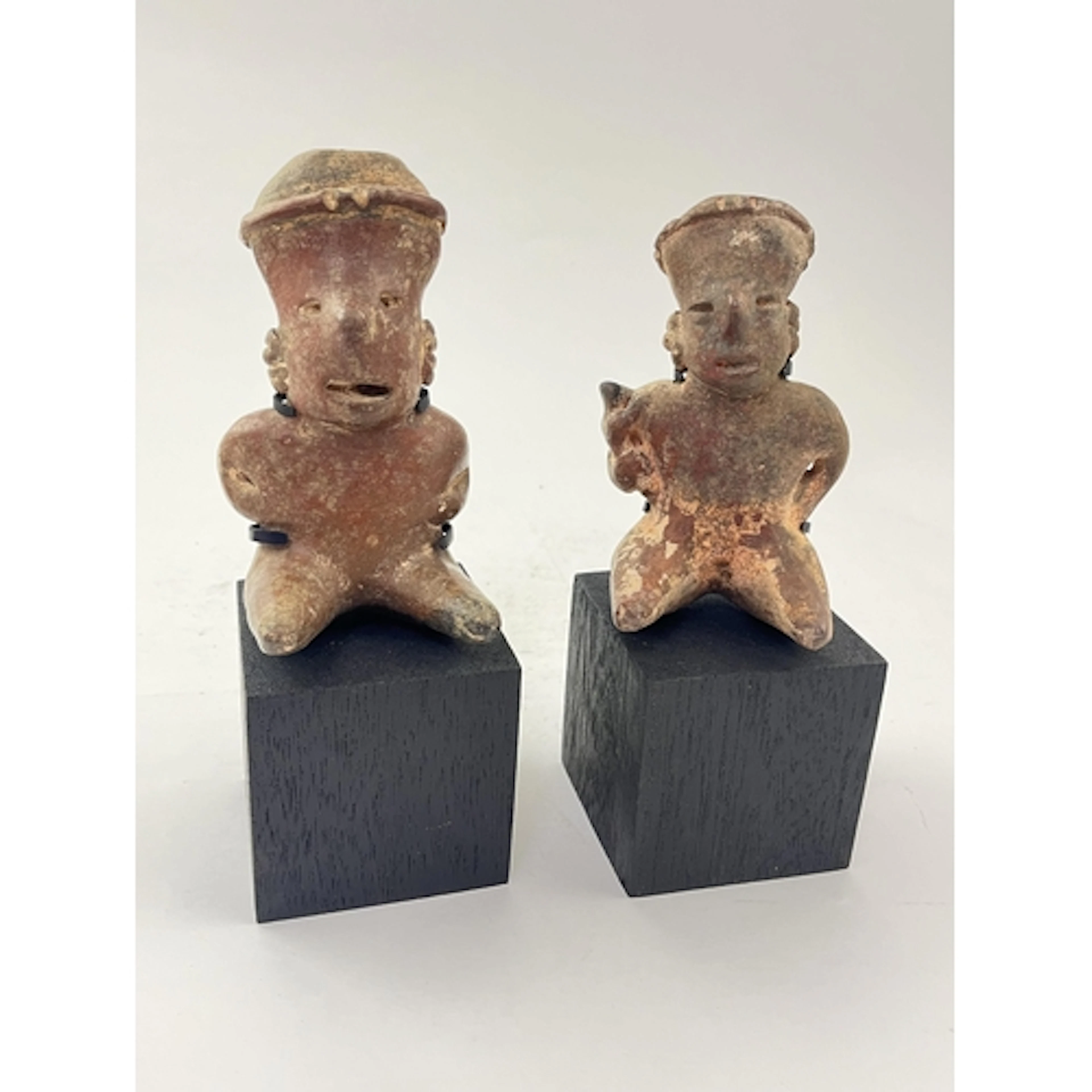 Two Pre-Columbian Nayarit polychrome seated figures, Western...