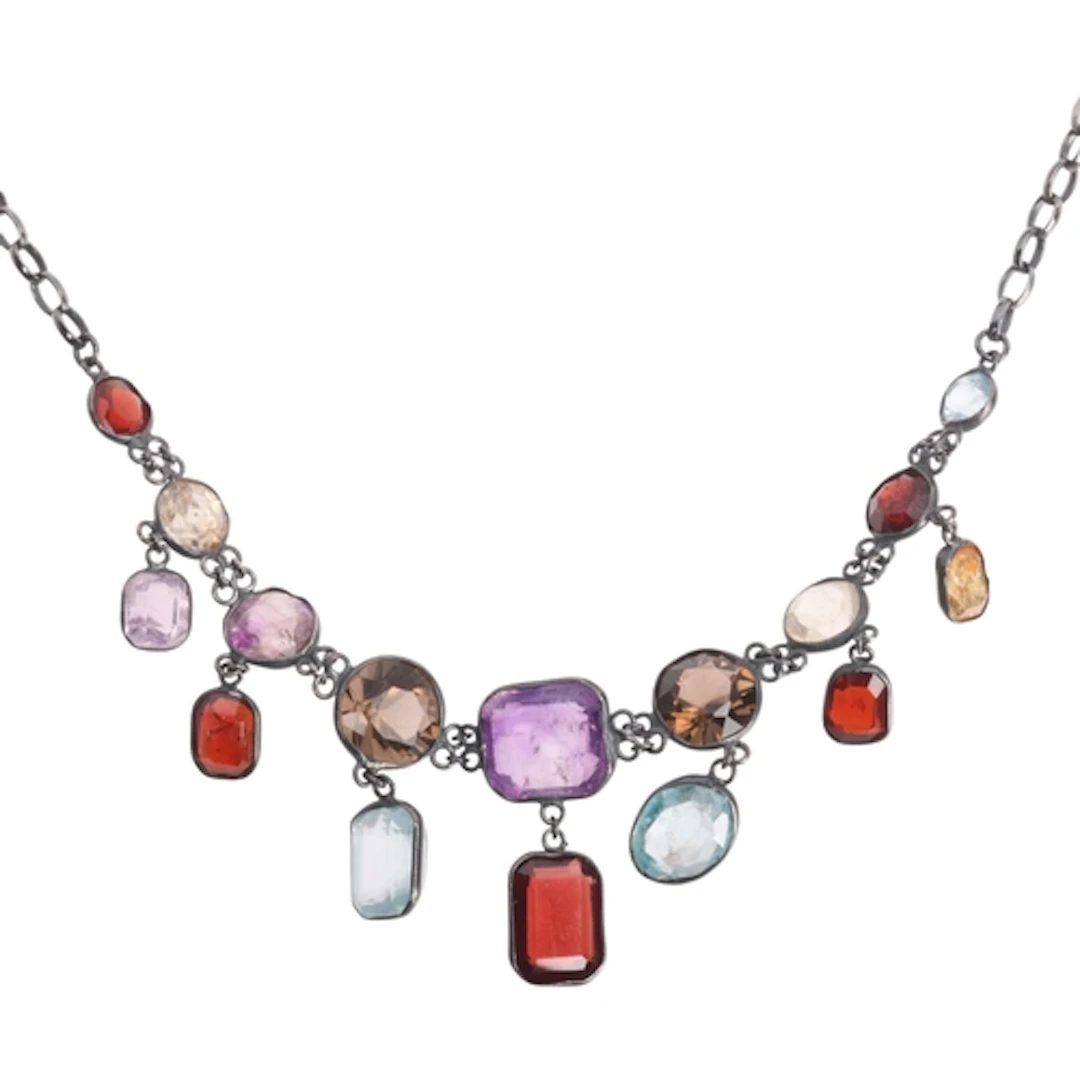 A sterling silver gem set fringe necklace, gemstones include...