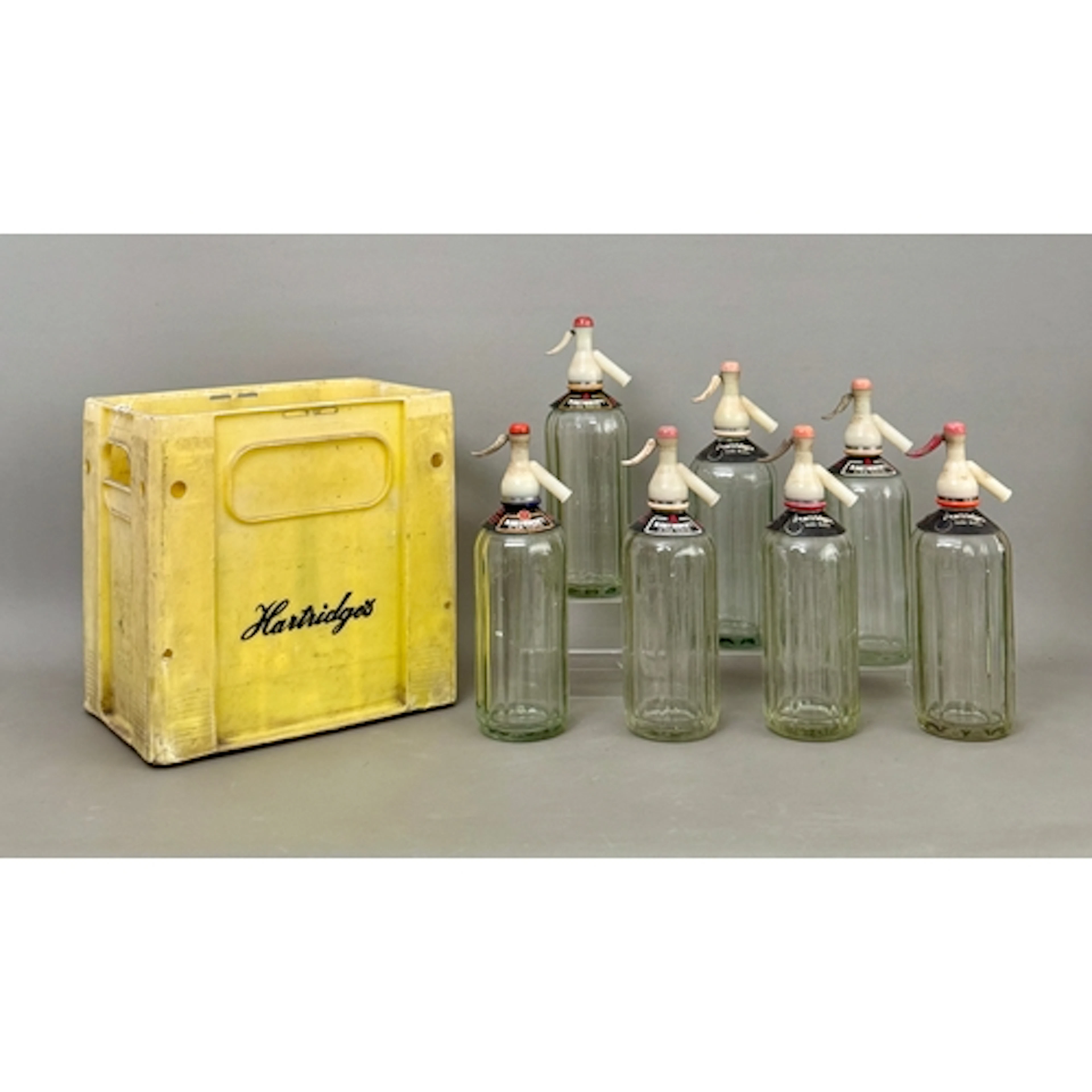 Seven vintage soda syphons - the 'Hartridges' crate holding ...