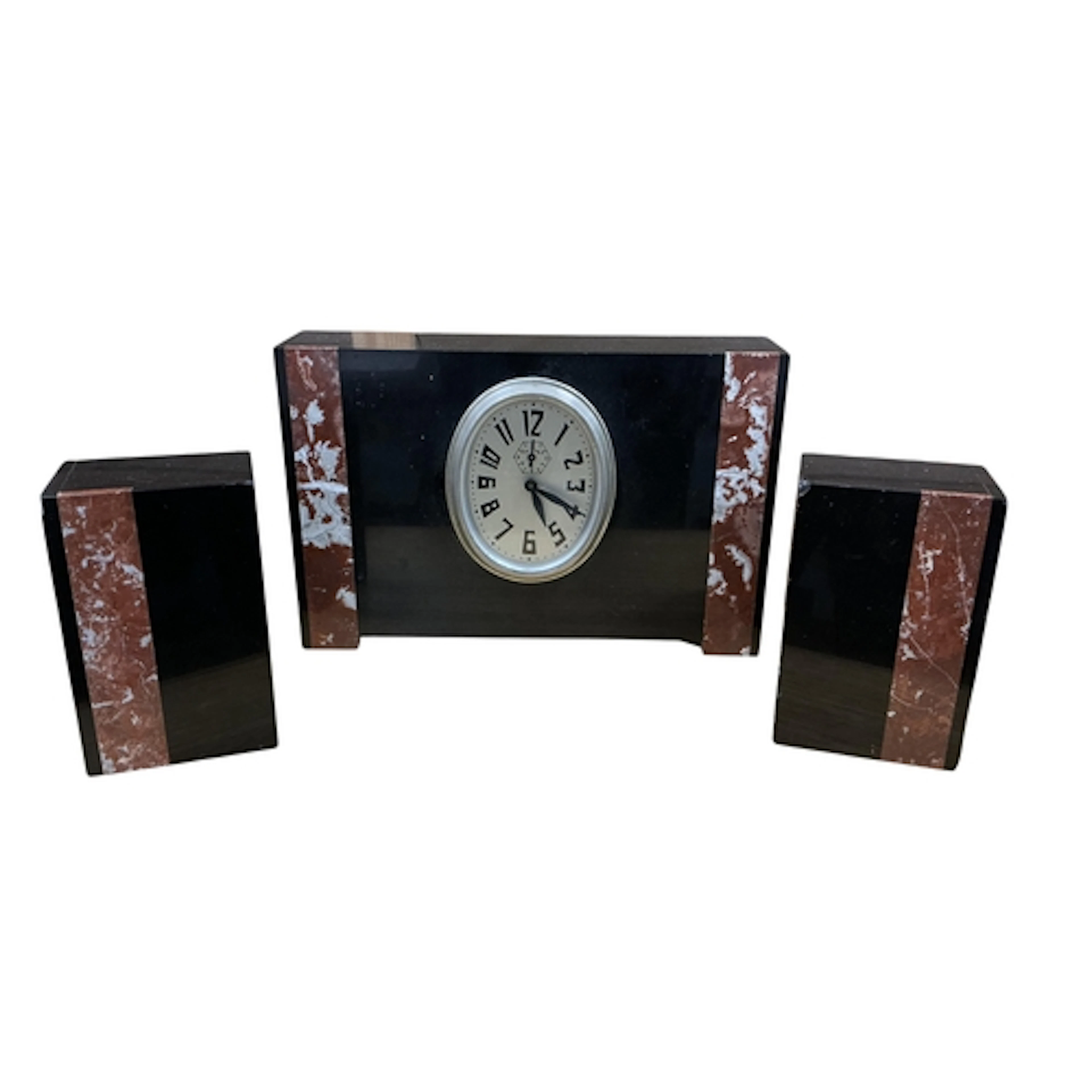 An Art Deco black slate and marble three piece clock garnitu...