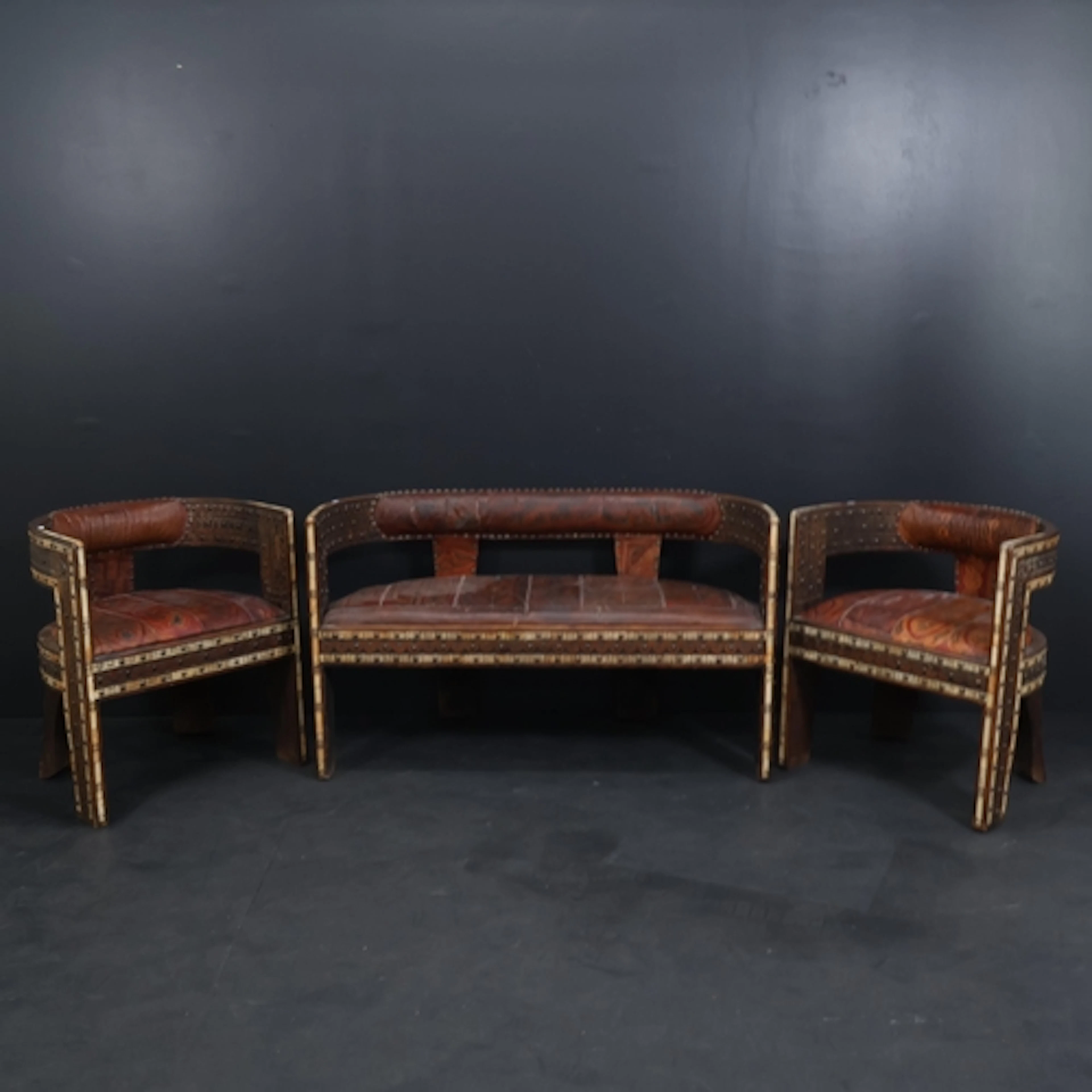 A Moroccan hardwood and leather upholstered three piece parl...