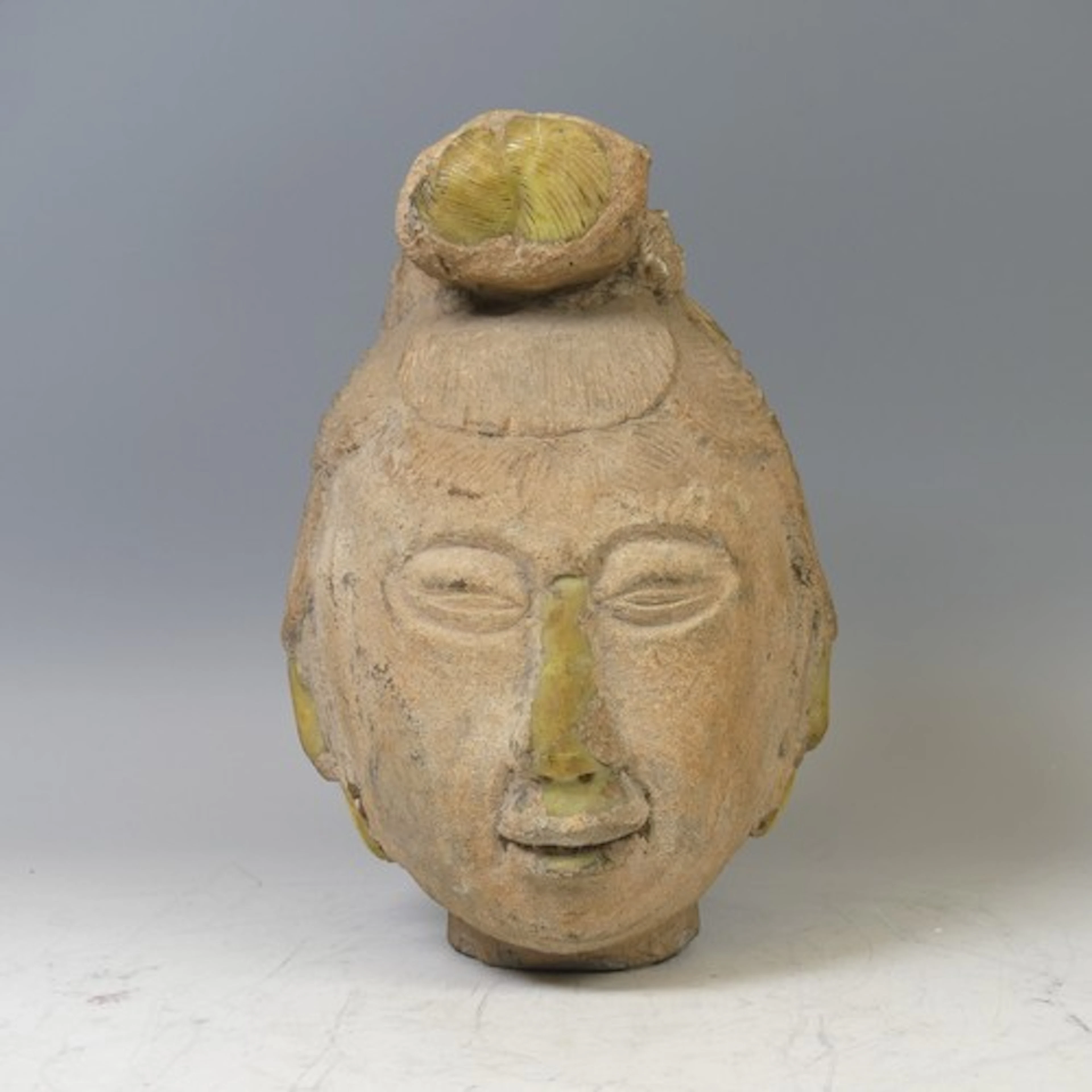 A large antique Chinese stone carving of the head of Guanyin...