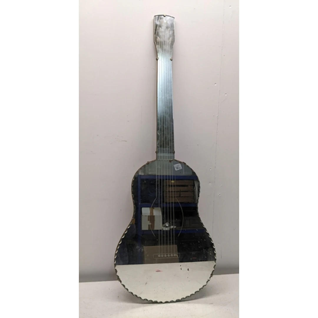 A vintage wall hanging mirror in the form of a guitar, engra...