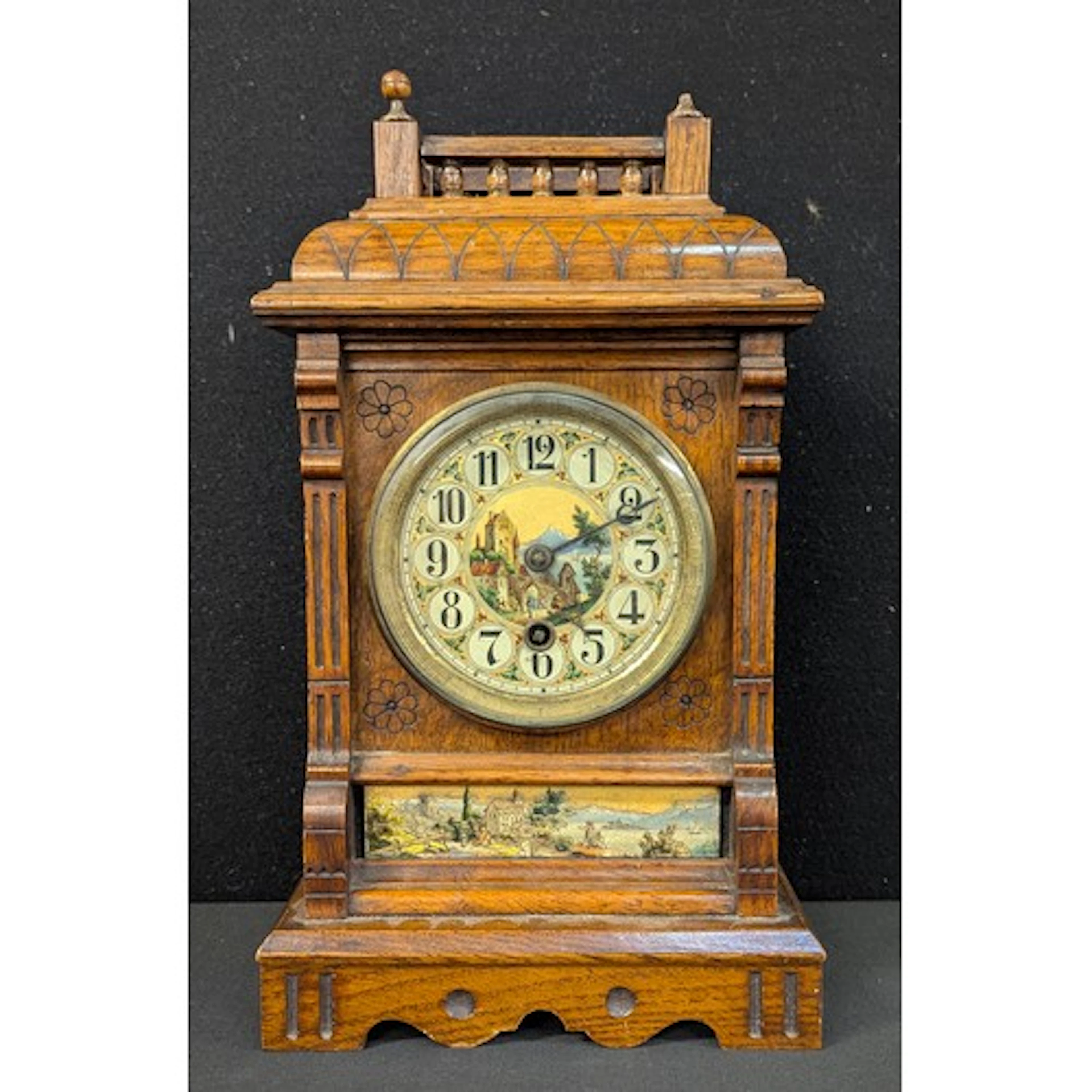 An Arts & Crafts style mantel clock, the dial and lower pane...