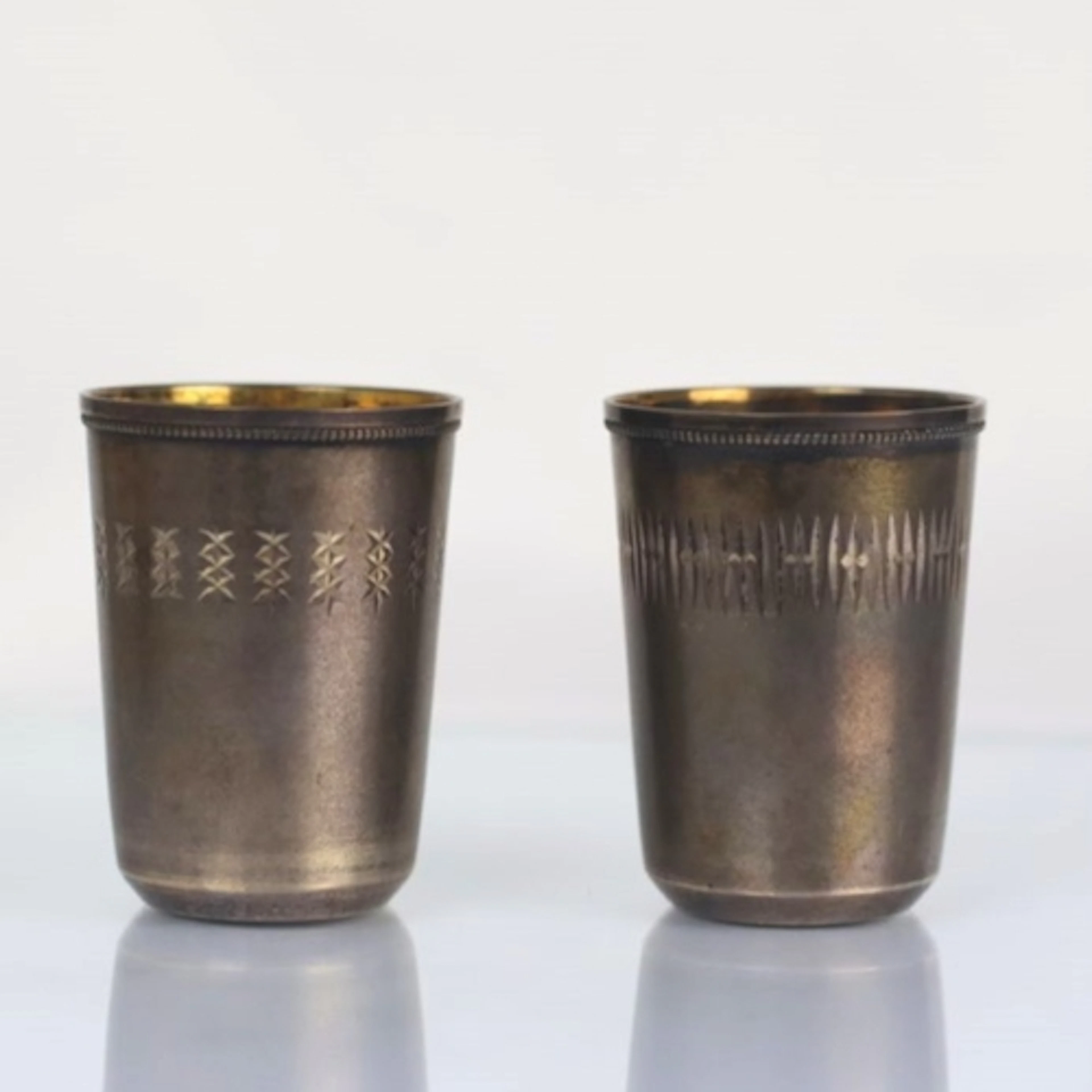 Two Russian mid/late 20th century white metal vodka tots, bo...
