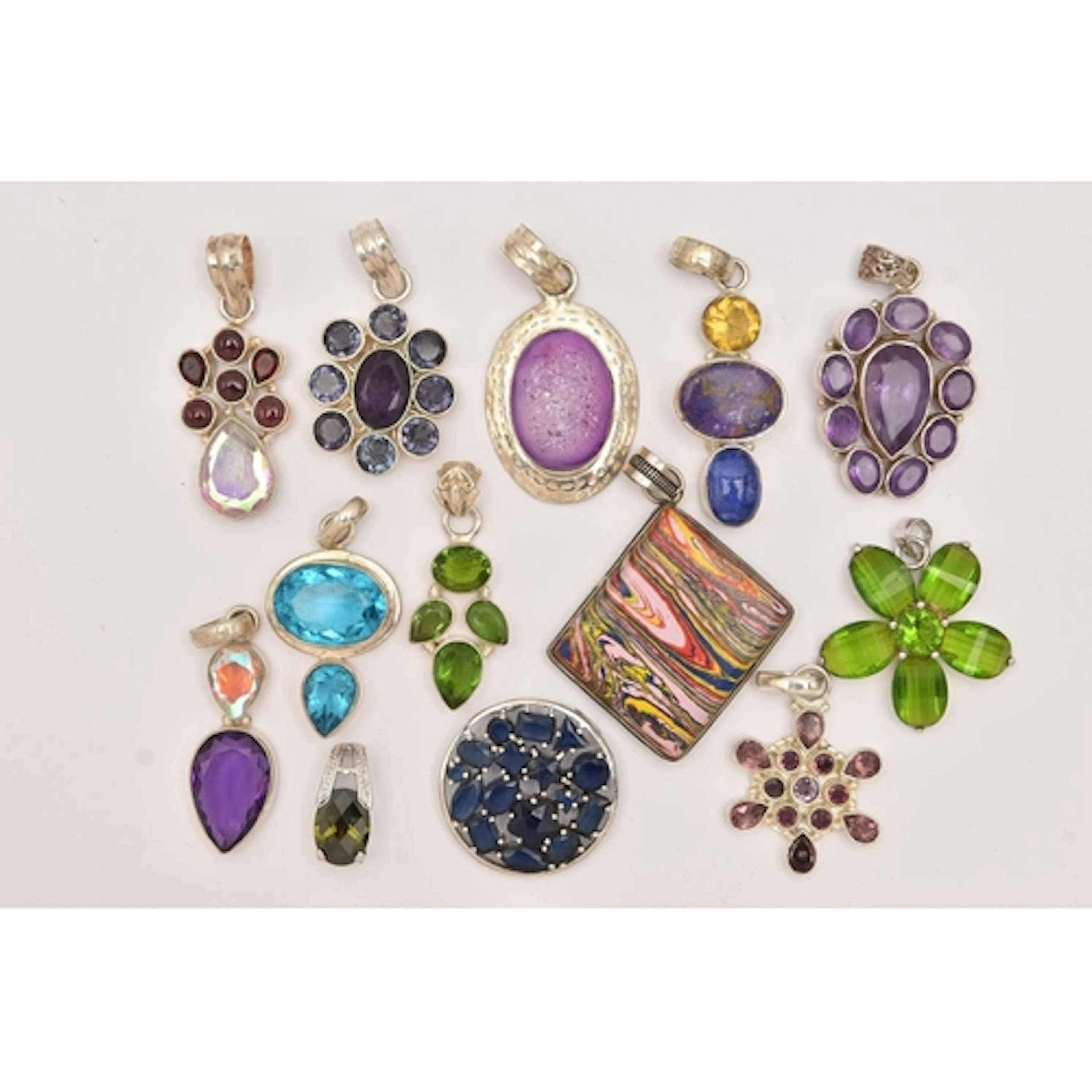 AN ASSORTMENT OF WHITE METAL GEM SET STATEMENT PENDANTS, 13 ...