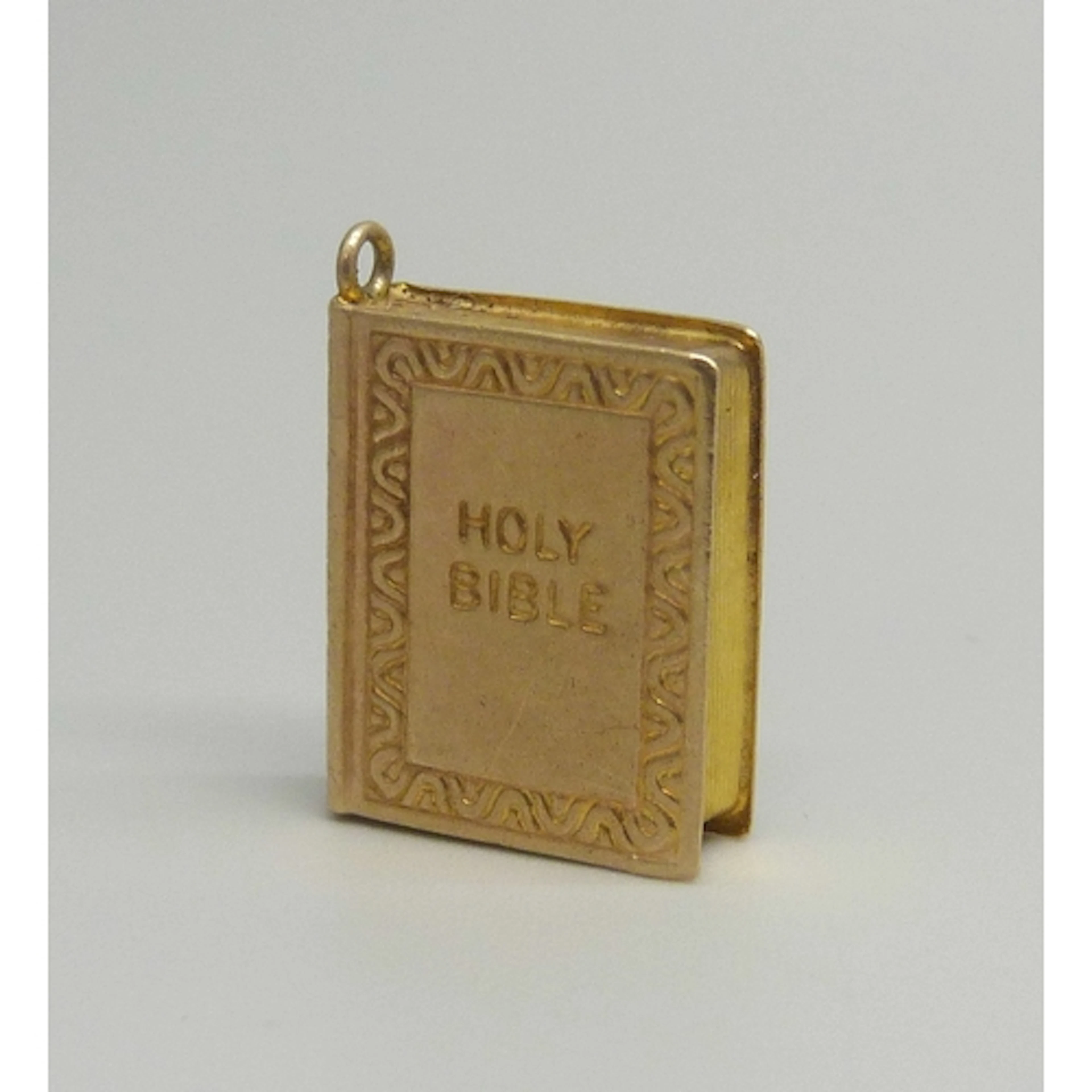 A 9ct gold charm in the form of a Holy Bible, hallmarked, 1....