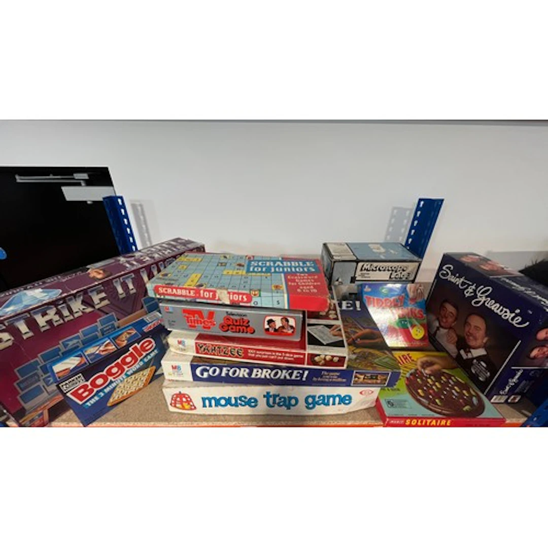 Shelf containing board games to include Mouse Trap, Strike i...
