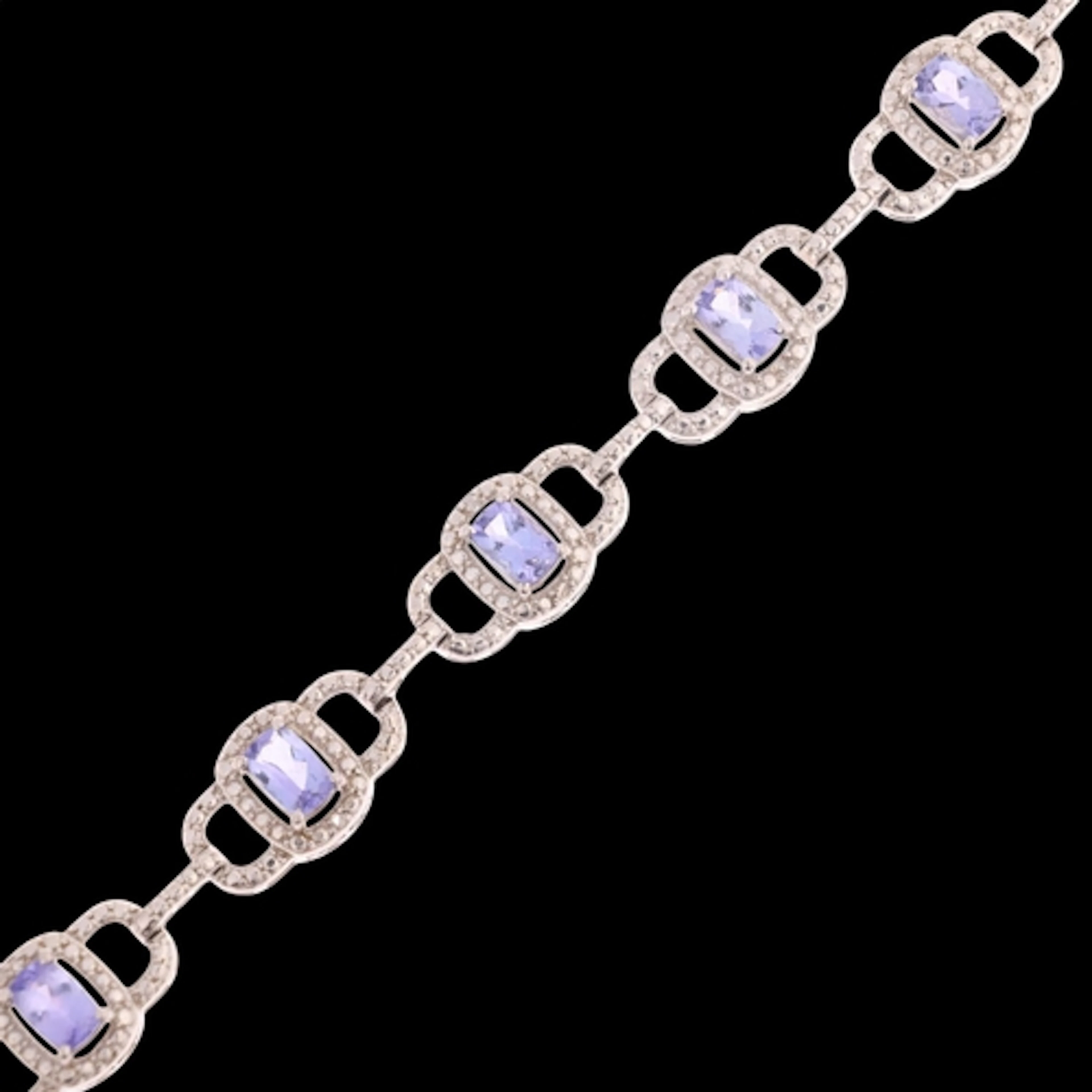 A sterling silver tanzanite and diamond panel bracelet, TJC,...