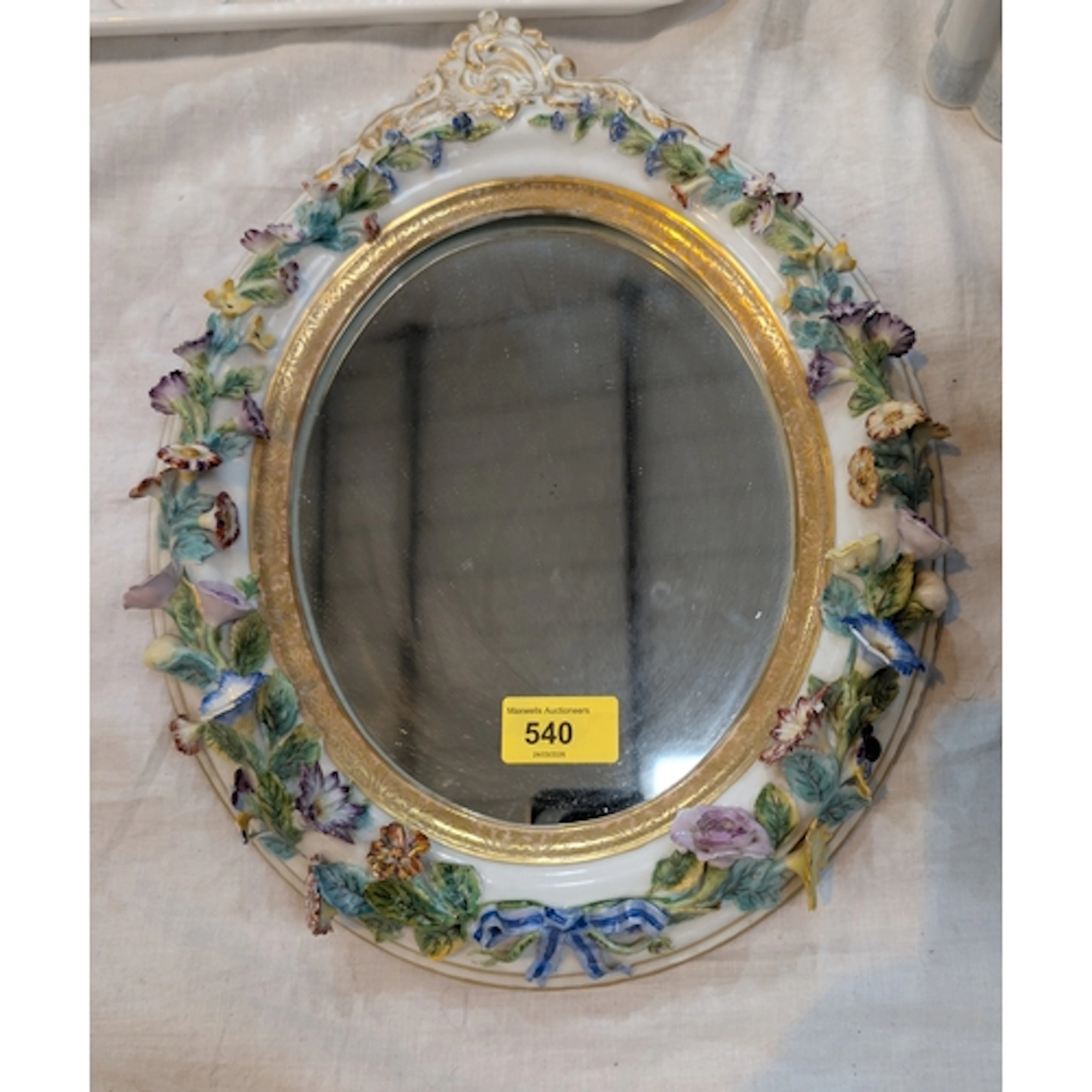 A 19th century continental porcelain encrusted oval framed m...