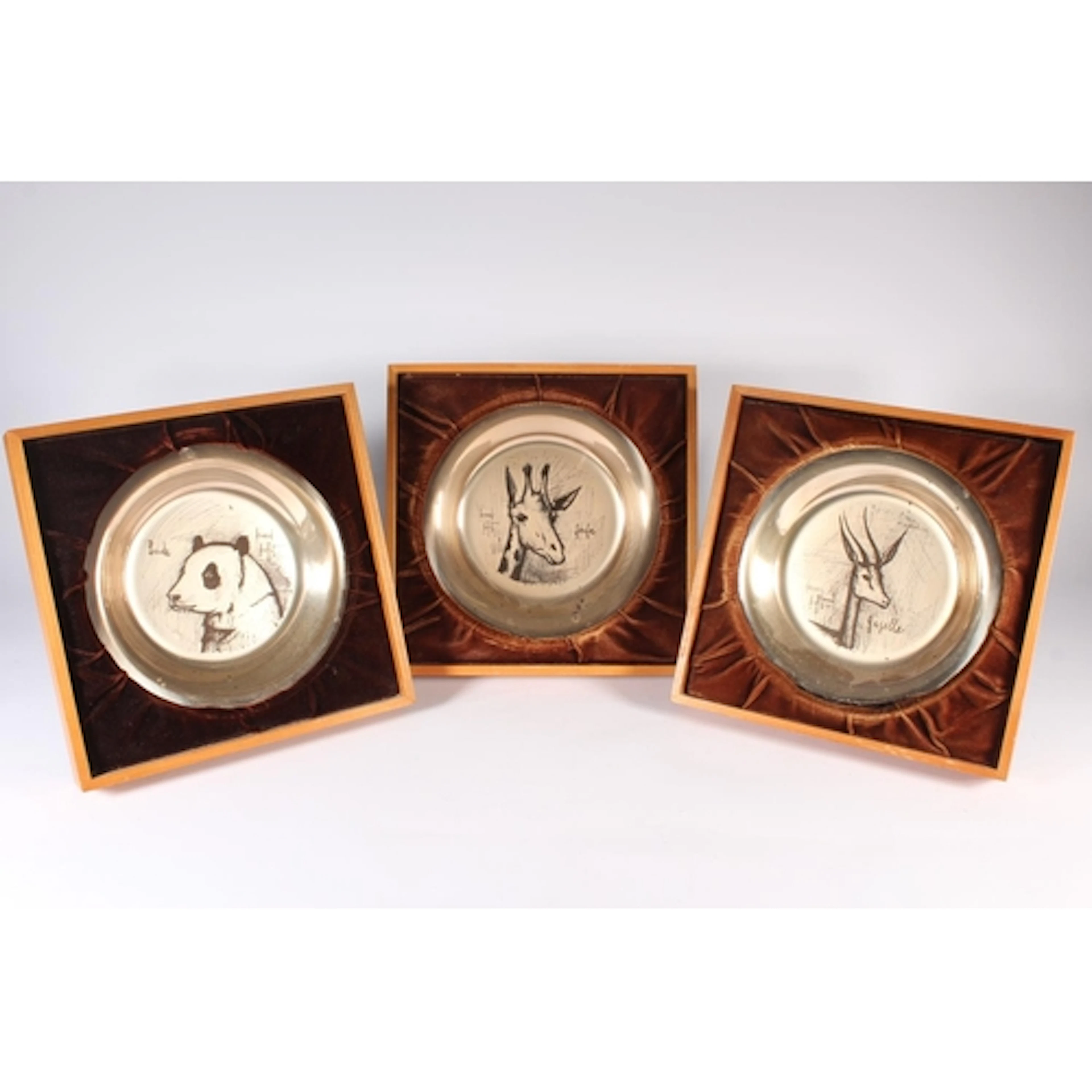 John Pinches, three silver dishes decorated with animal port...