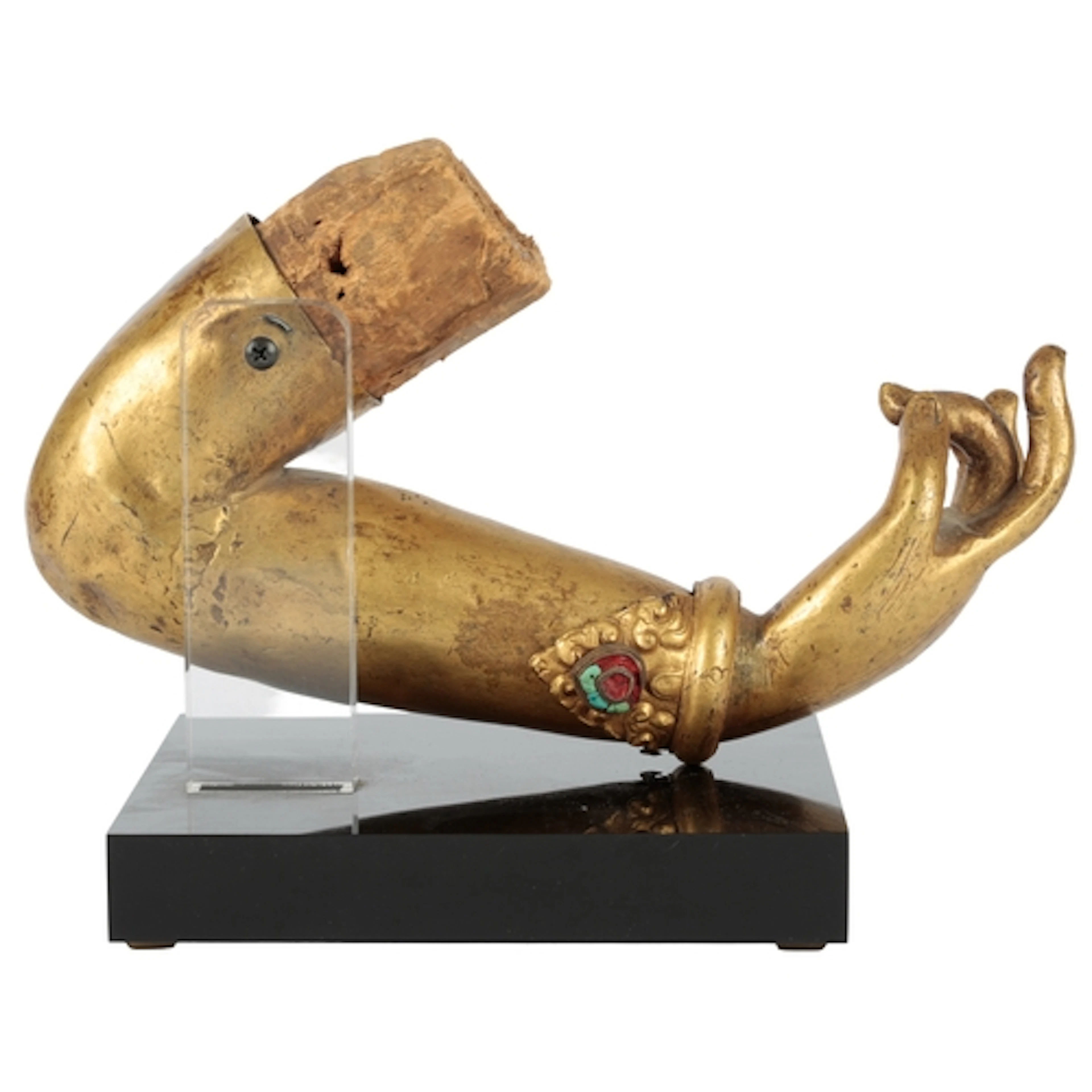 A Tibetan gilt bronze fragmentary hand and repoussé work arm...