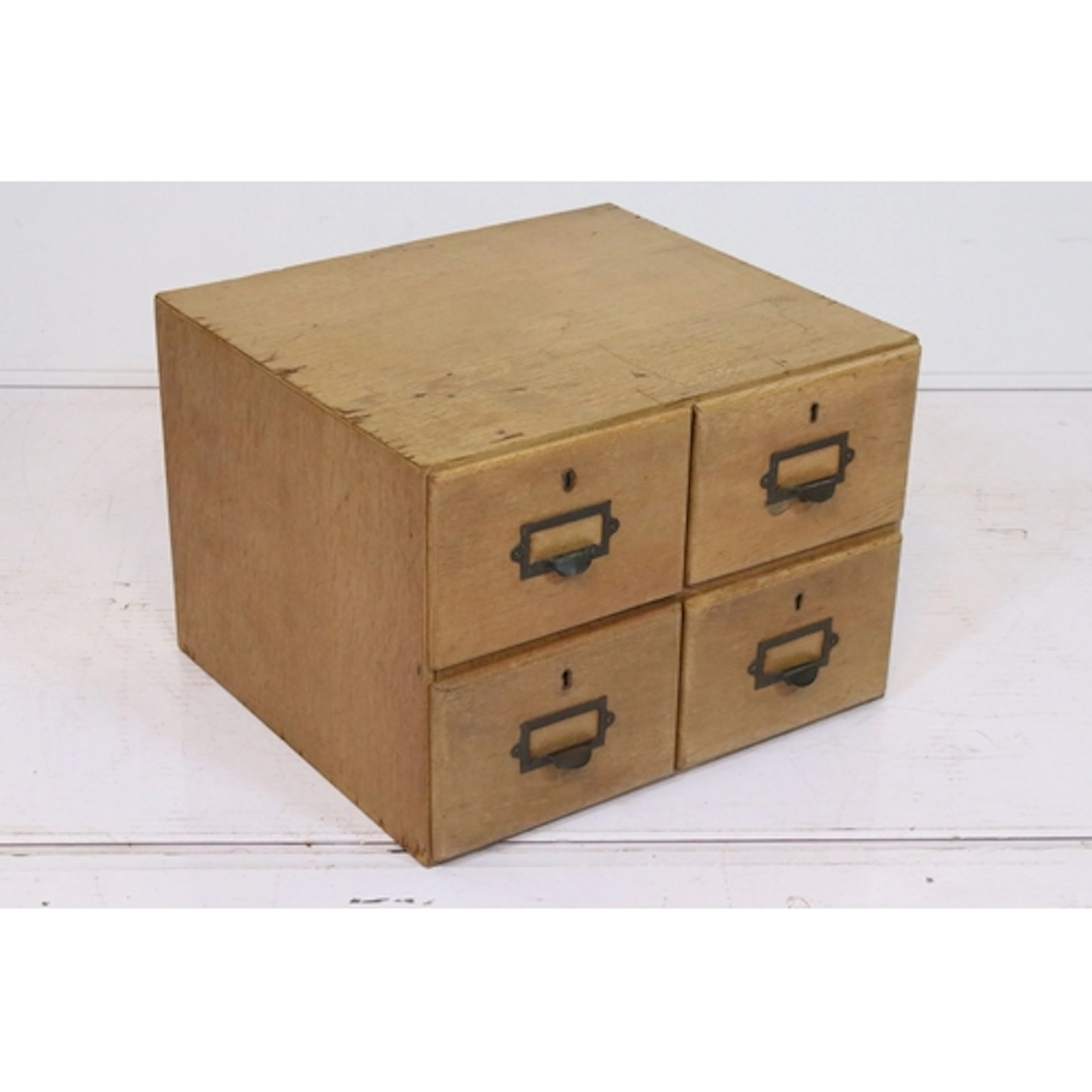 Mid 20th century light oak stationery cabinet, having four d...