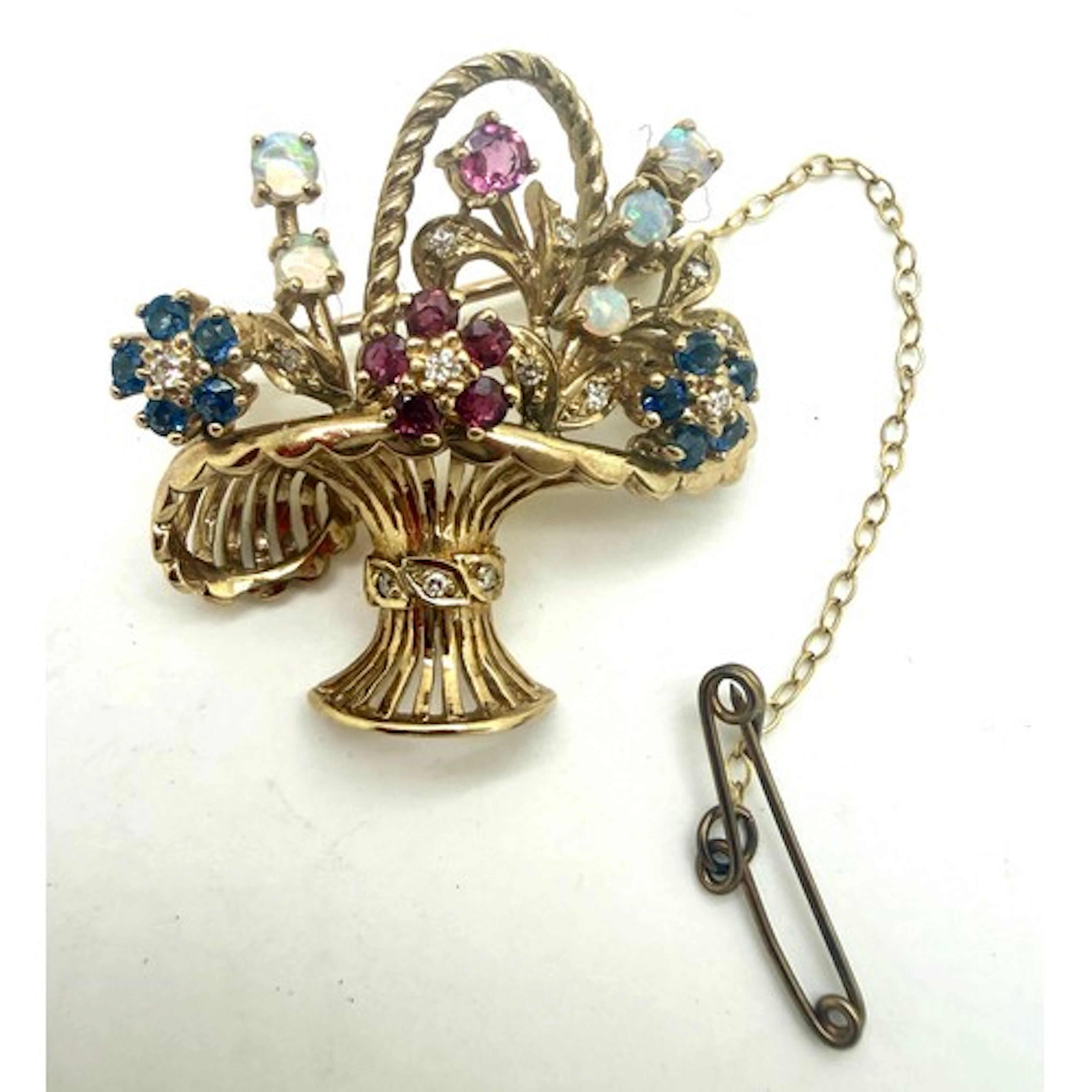 A 9 carat gold brooch in the form of a basket set with multi...