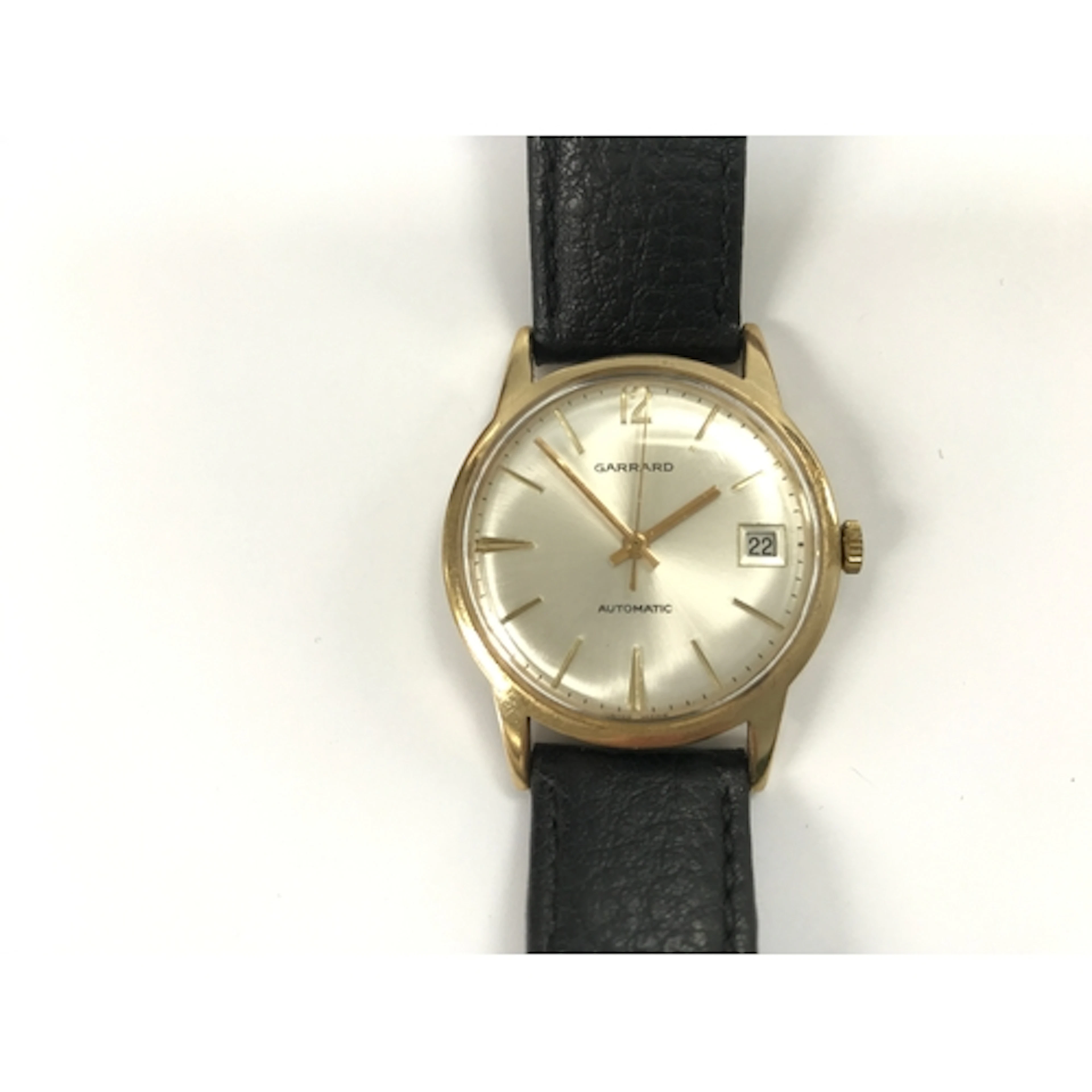 A 9k gold gents Garrard wrist watch with box. Winds and runs...