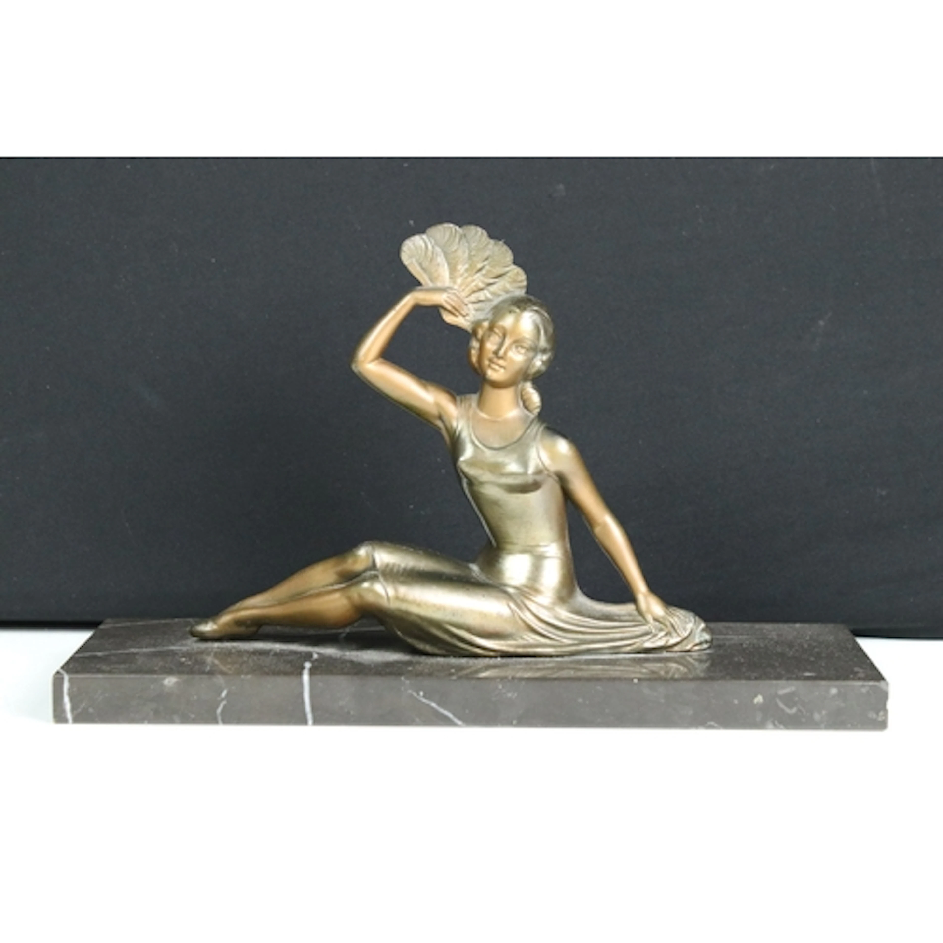 Art Deco bronzed metal sculpture of a reclining woman holdin...