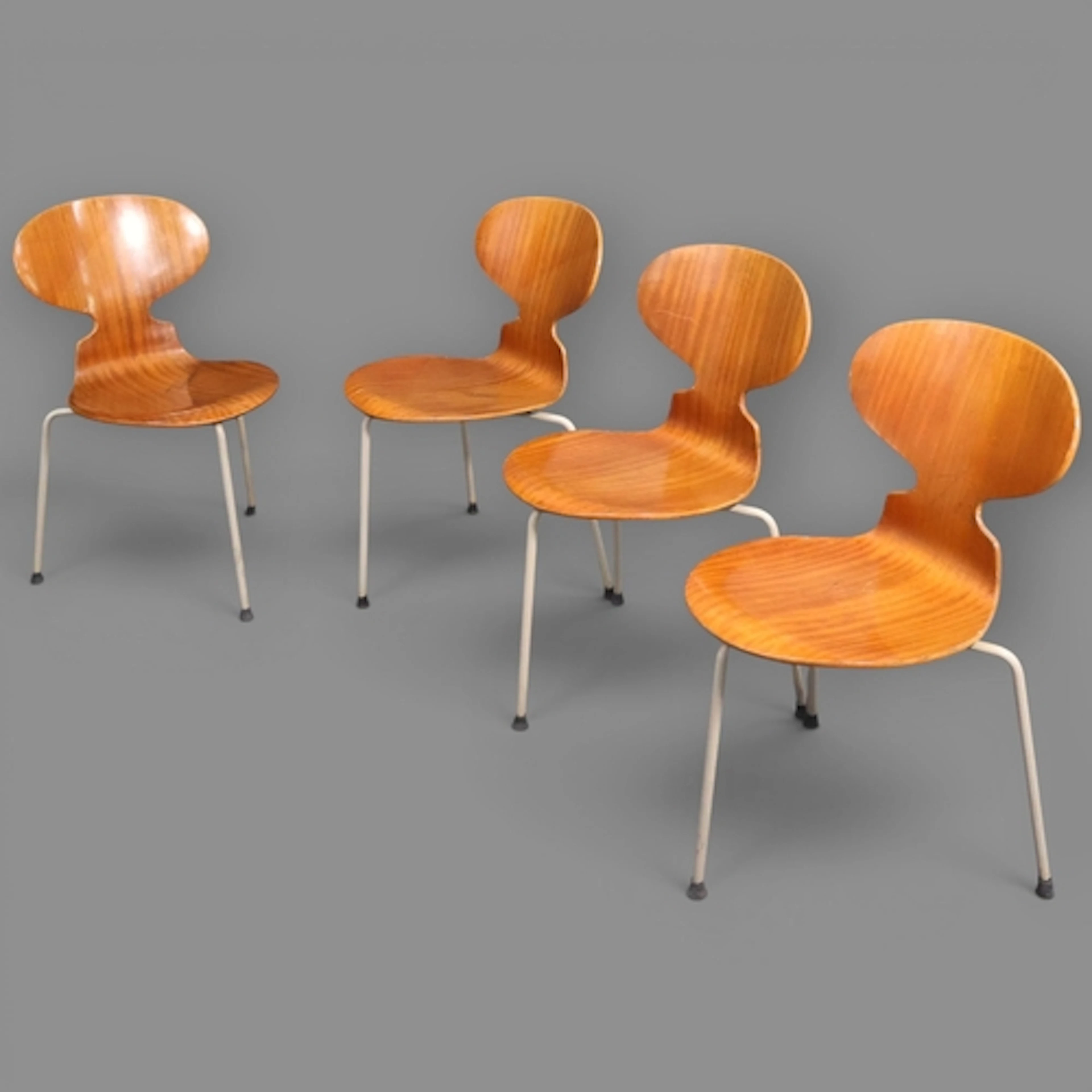 A set of four mid-century Arne Jacobsen 3 legged teak ant ch...