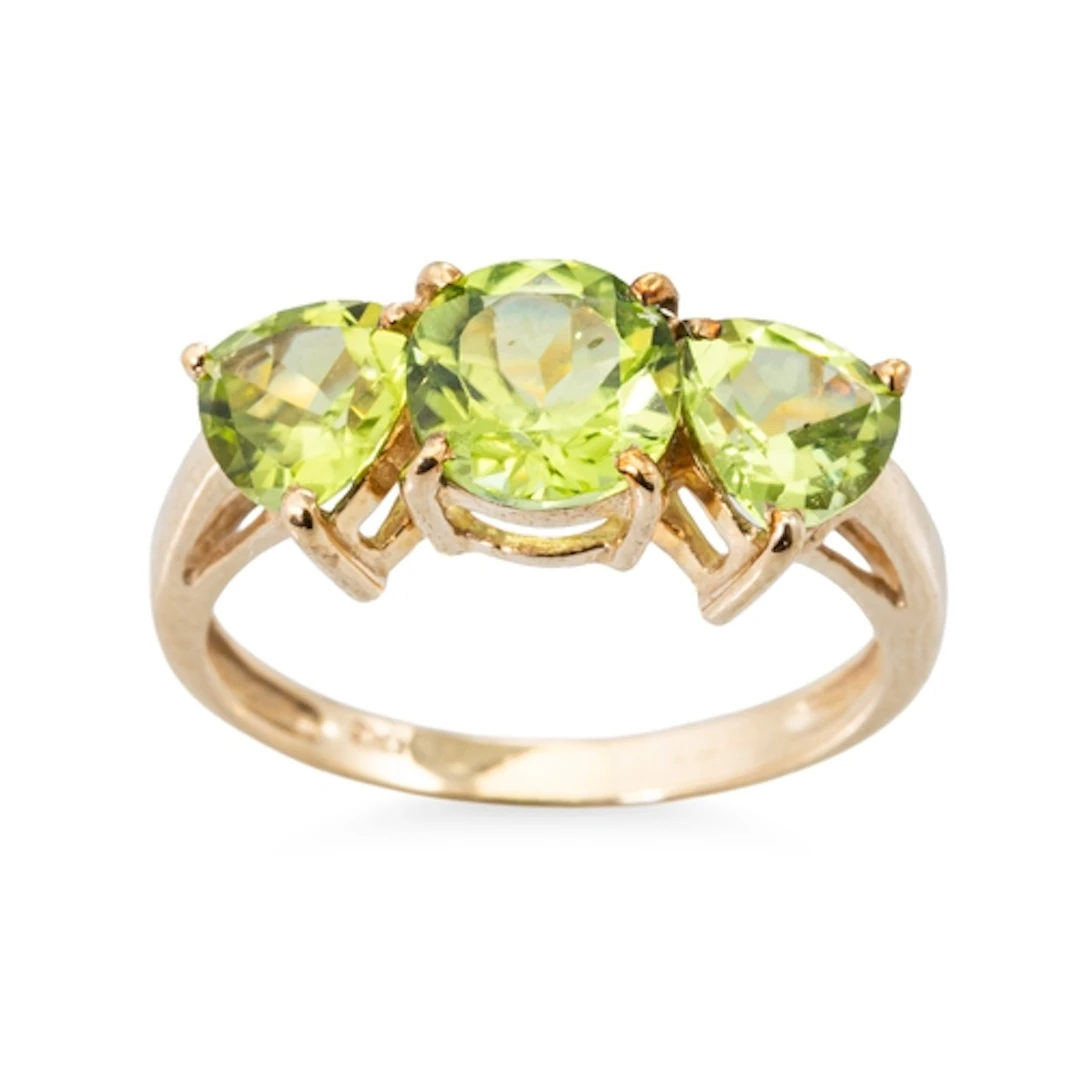 A PERIDOT THREE STONE RING, mounted in 9ct gold, size N