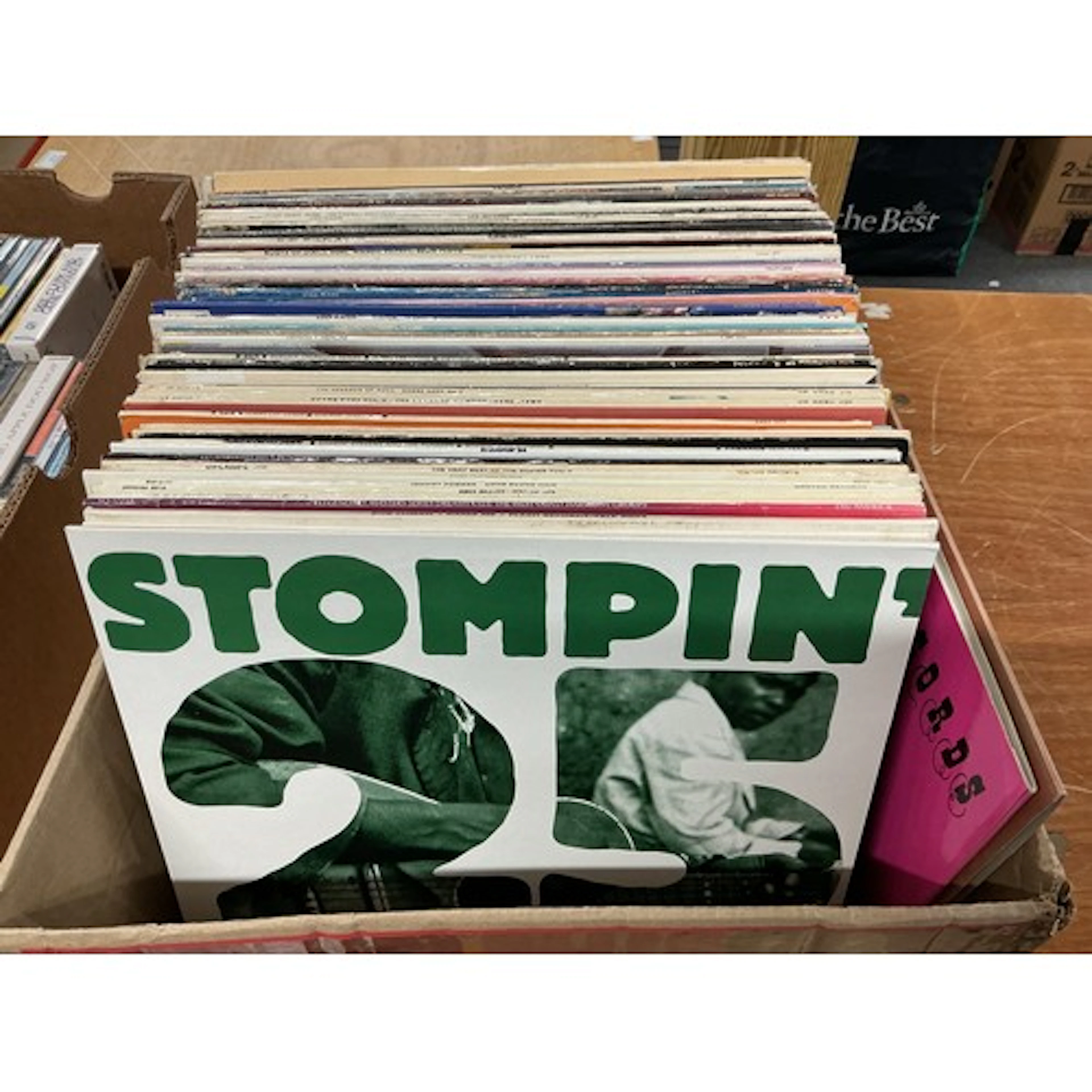A box of LPs and 12” singles by various artists including bl...