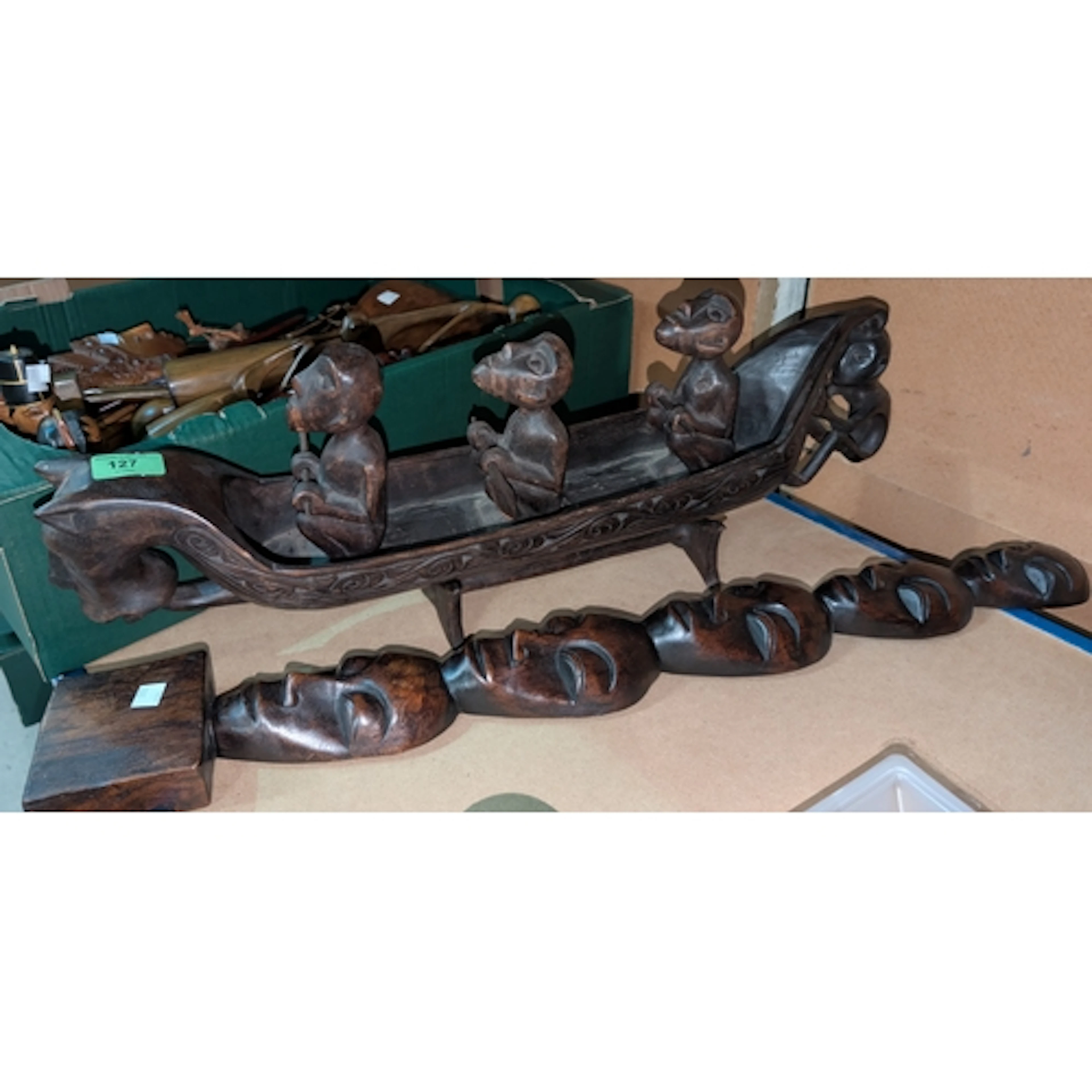 An African ethnic carved group, "3 Men in a Boat", a Maori ...