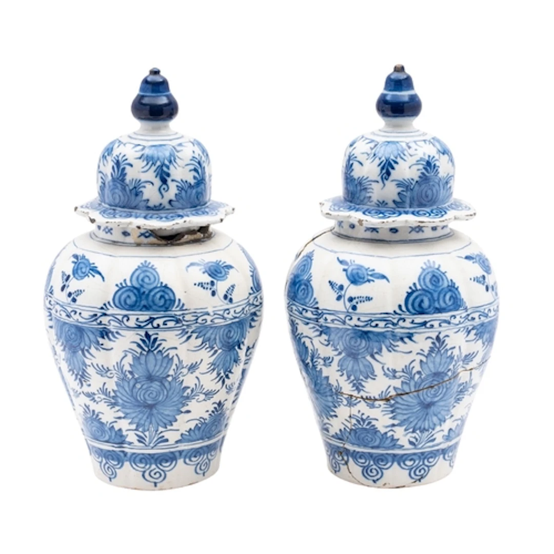 A pair of Dutch Delft lobed jars and domed covers each paint...