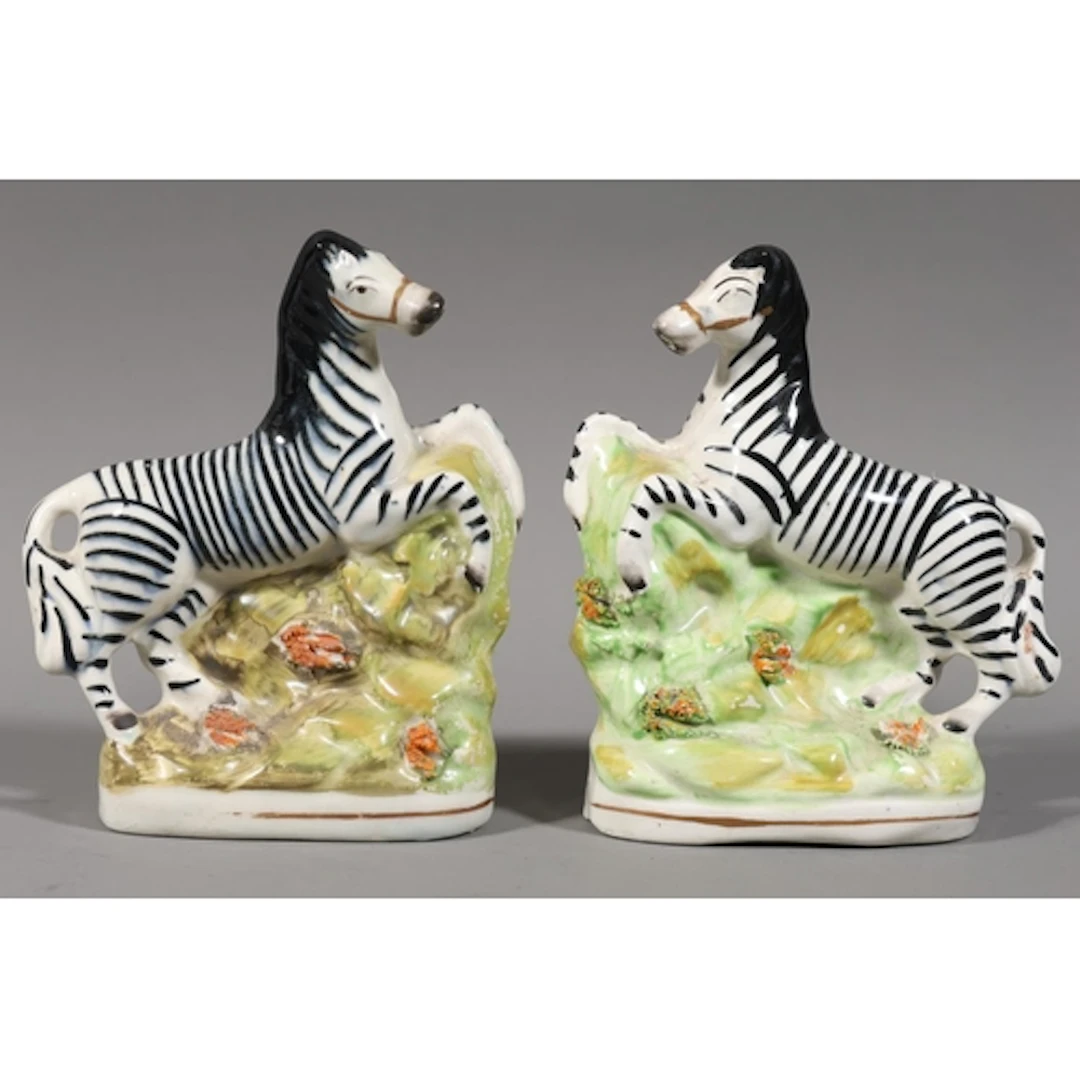 Pair of Staffordshire style pottery models of zebras, 17cm t...